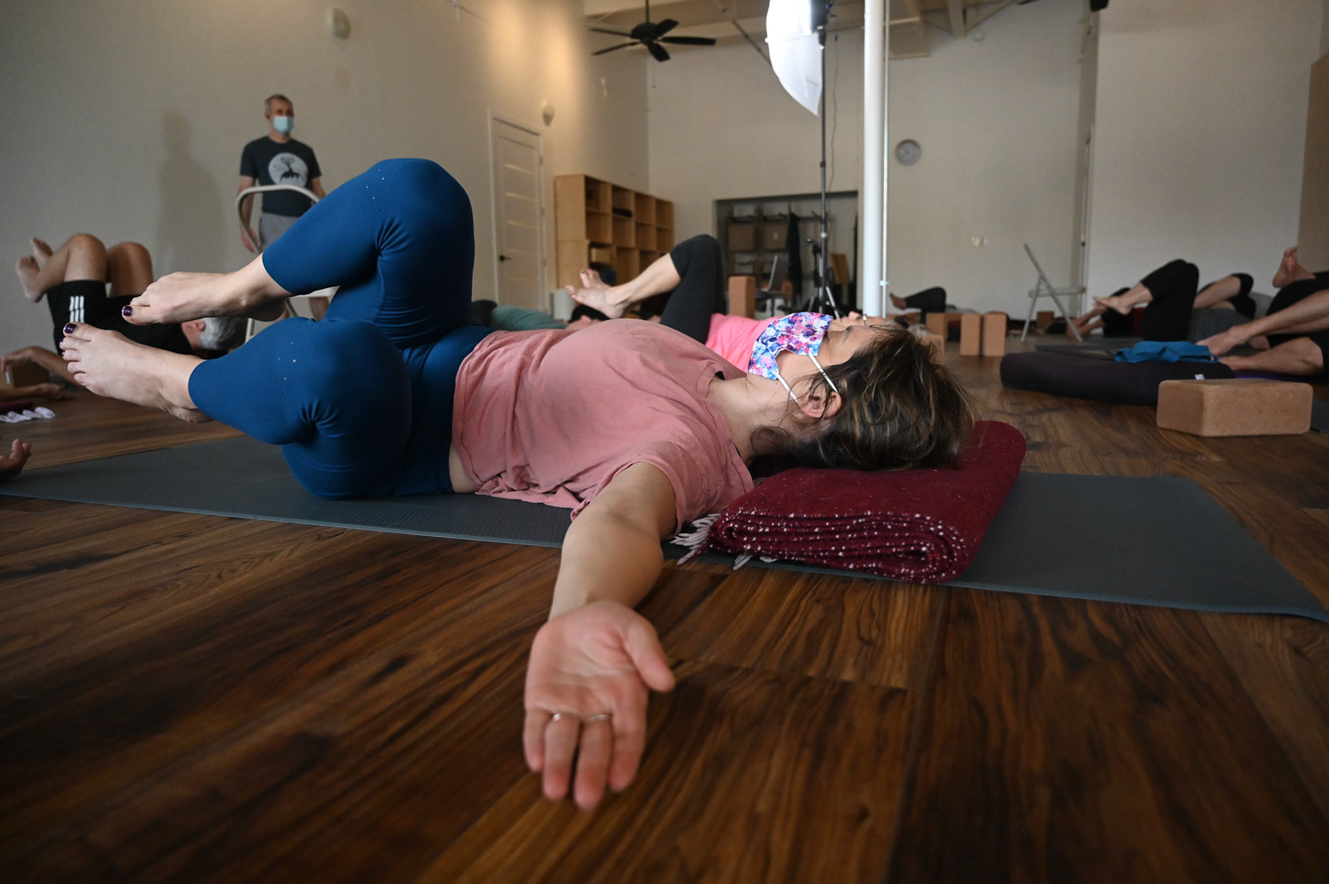 Austin Yoga Tree members practice shavasana, the resting and restorative pose done at the end of a yoga session.  Shot for Community Impact.