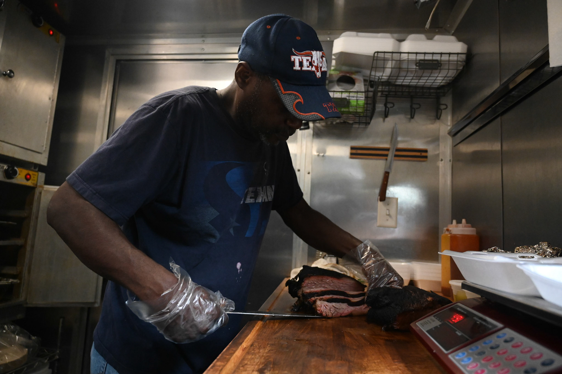 Pitmaster Orie King serves up a brisket platter at OG’s Barbeque at the Cedar Pork food truck park. Shot for Community Impact.
