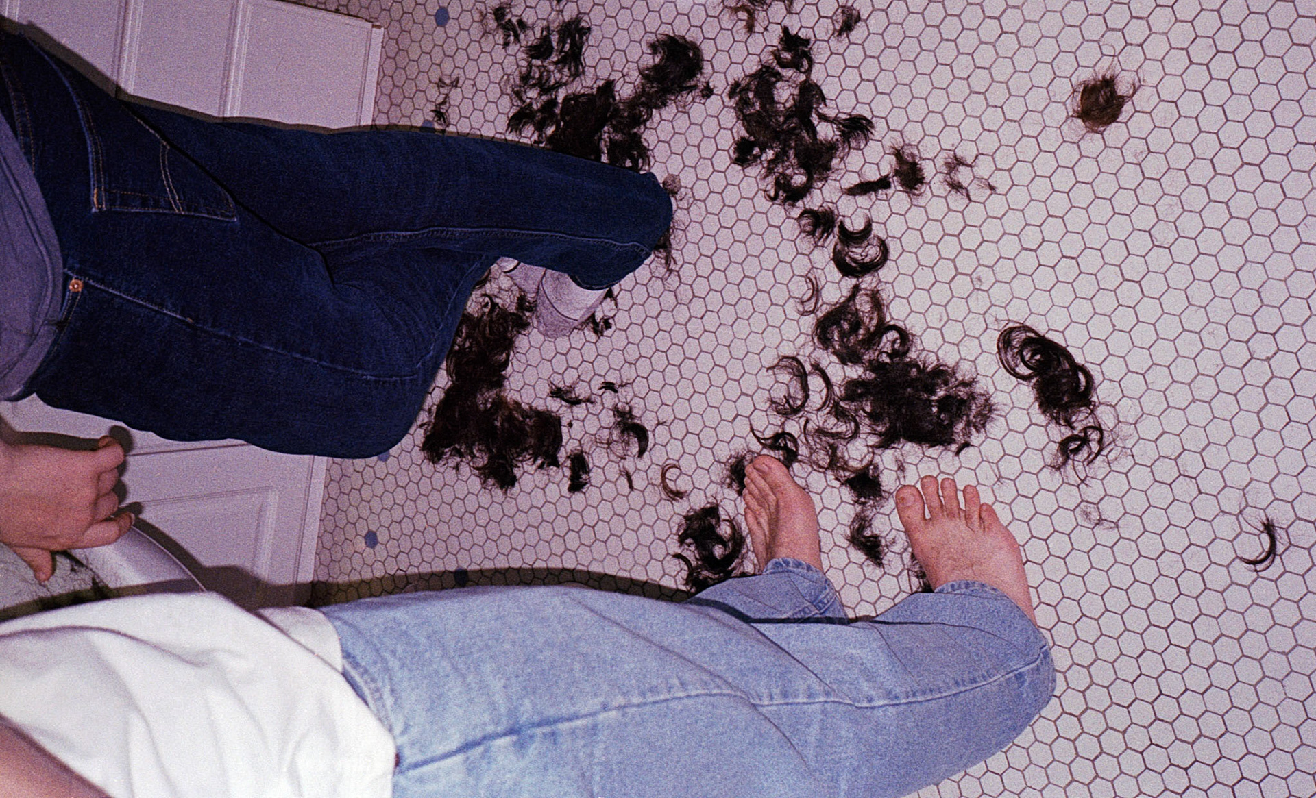 Ali's thick locs litter the floor.
