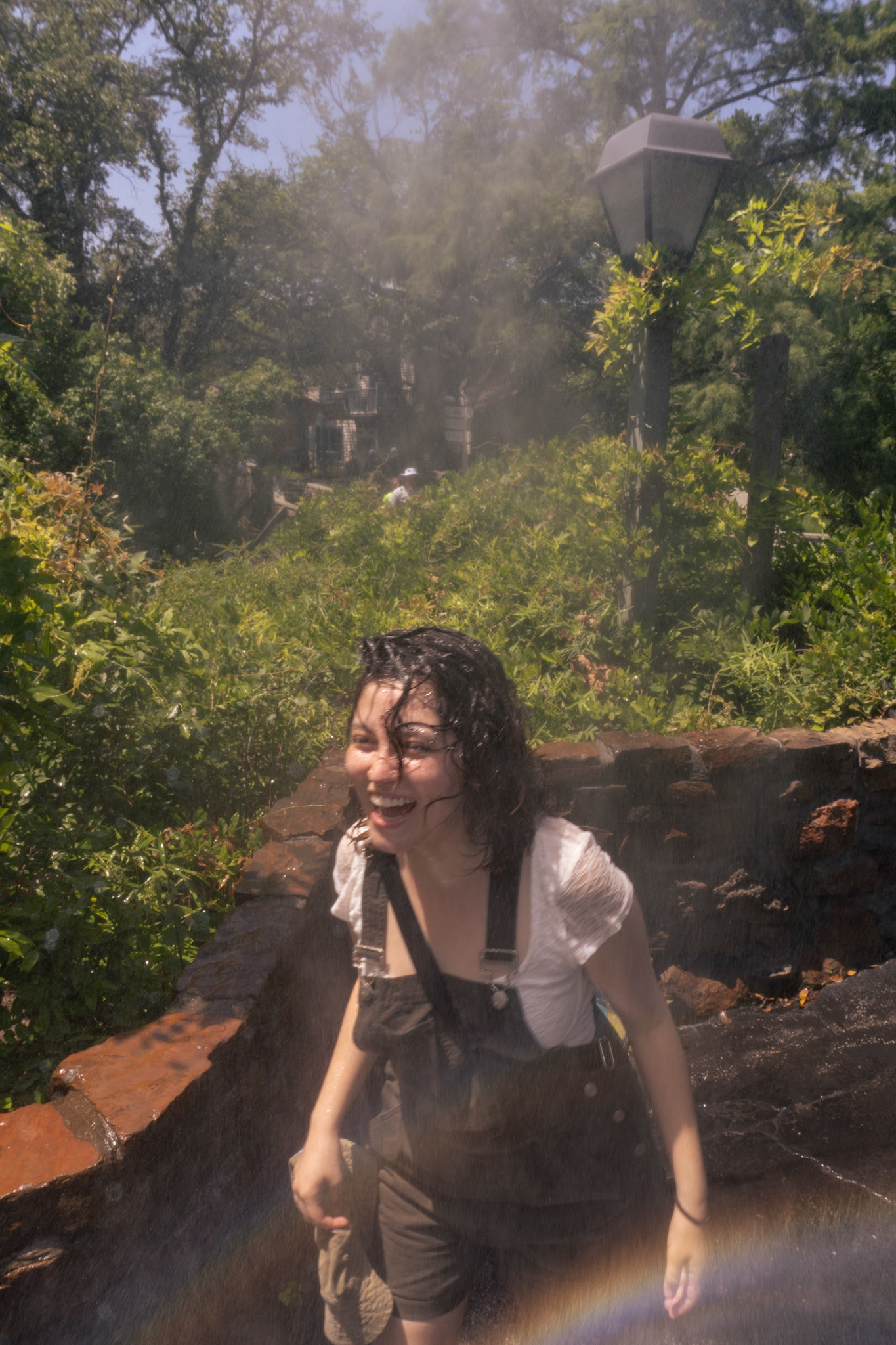 Soto-Ferate cools off in misting fans at Six Flags over Texas on June 13, 2024.