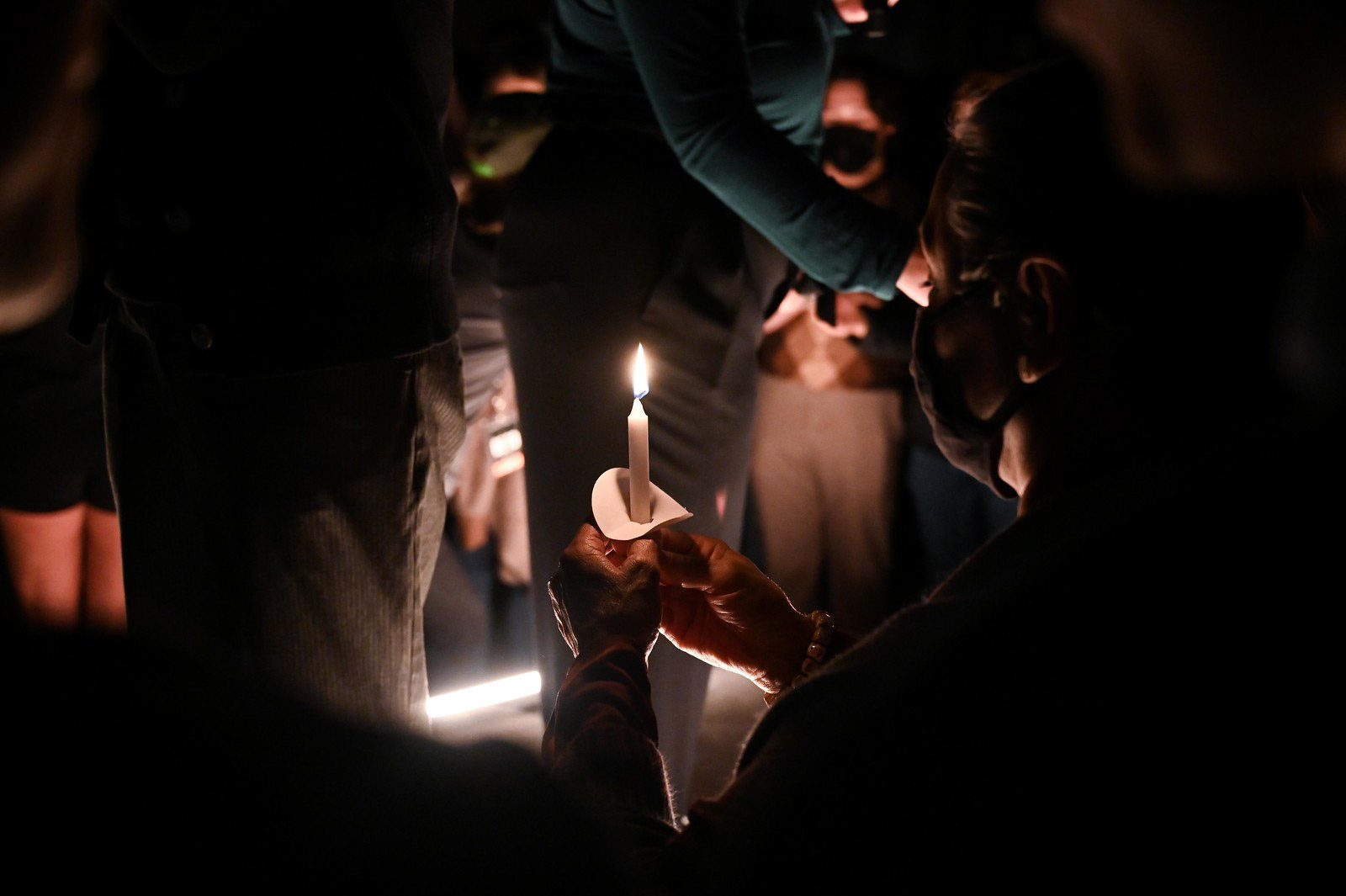 An attendee holds a candle during the candle lighting at the Beto O'Rourke rally on Feb. 9, 2022. Attendees held candles in honor of the 246 lives lost during Storm Uri in Feb. 2021.  