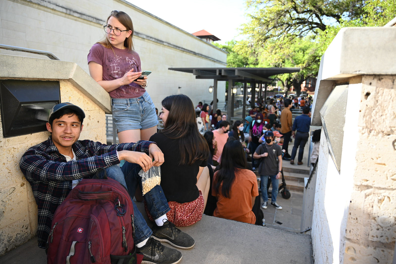 Students socialize, eat and do homework while waiting in line for Hank Green. Green creates educational science content on YouTube and TikTok, hosts several podcasts and co-created VidCon.  