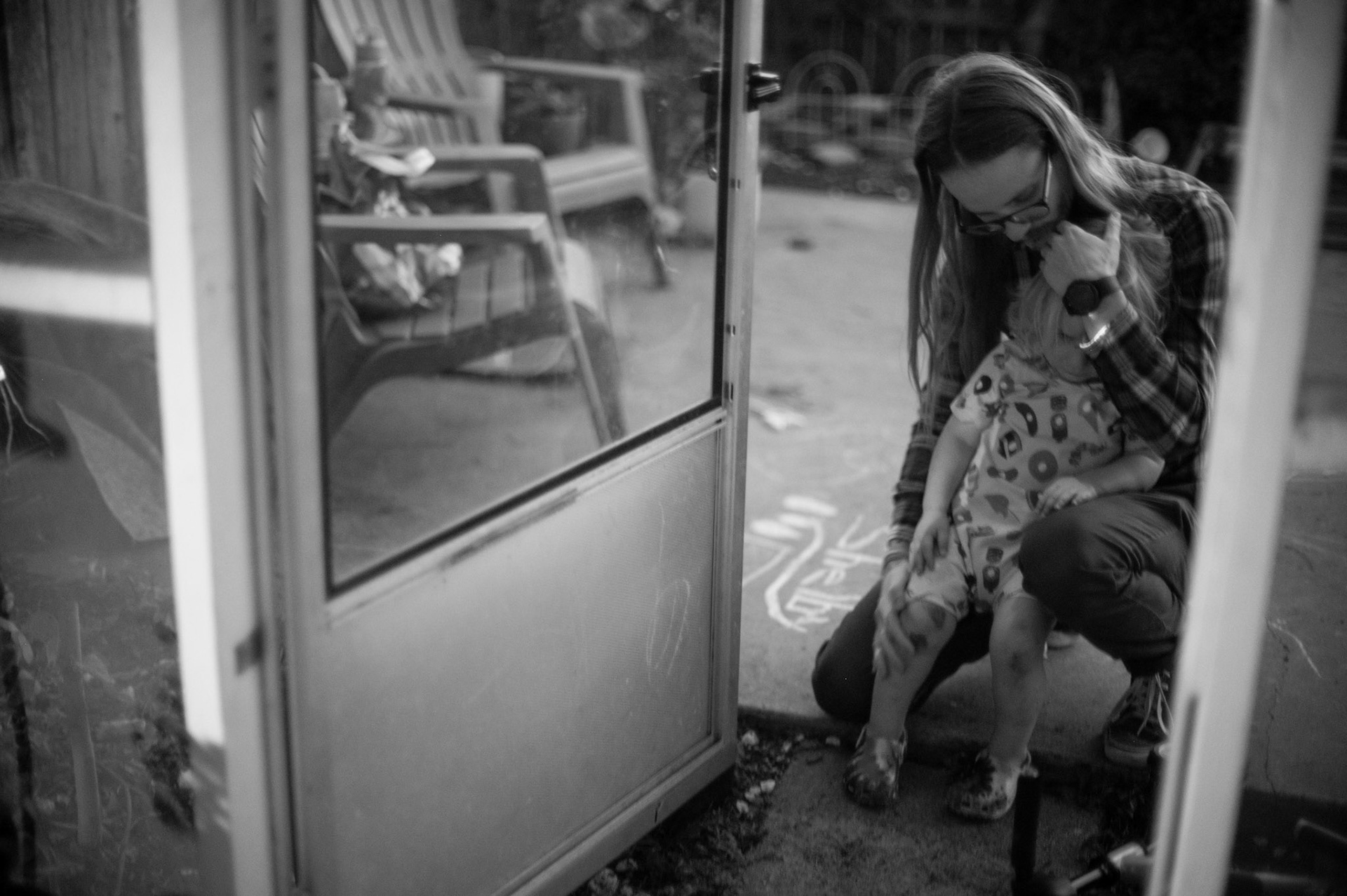 Nick Morrow comforts Shelby, 2, after an injury outside in Wooten, Austin, on Feb. 6, 2023, where the family has been six days without power after Austin's freeze.