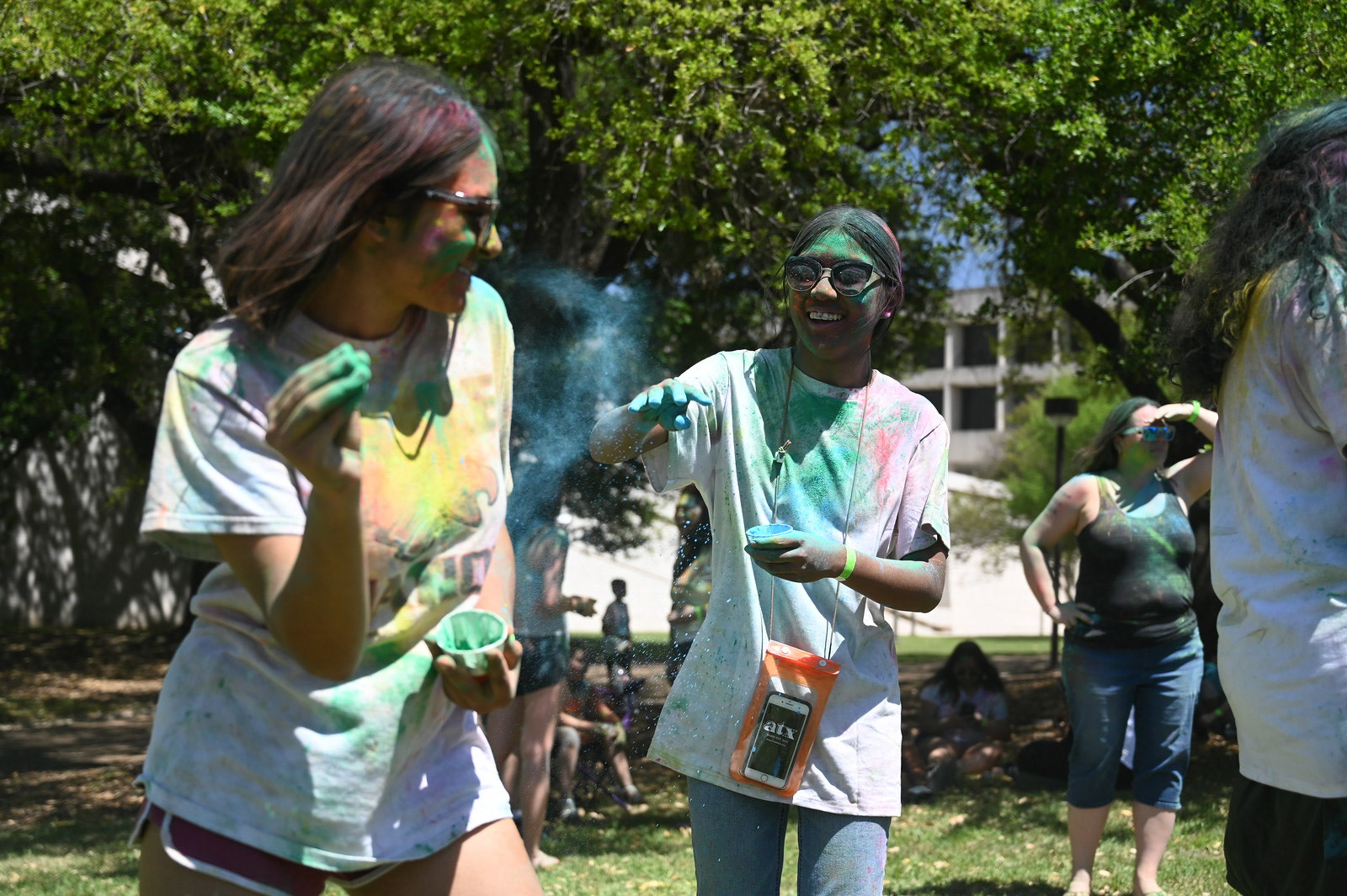 Two attendees chase each other with rang at the Holi Fest on April 9, 2022. The 2022 Holi Fest theme was "Coloring Outside the Lines," in a celebration of diversity.  