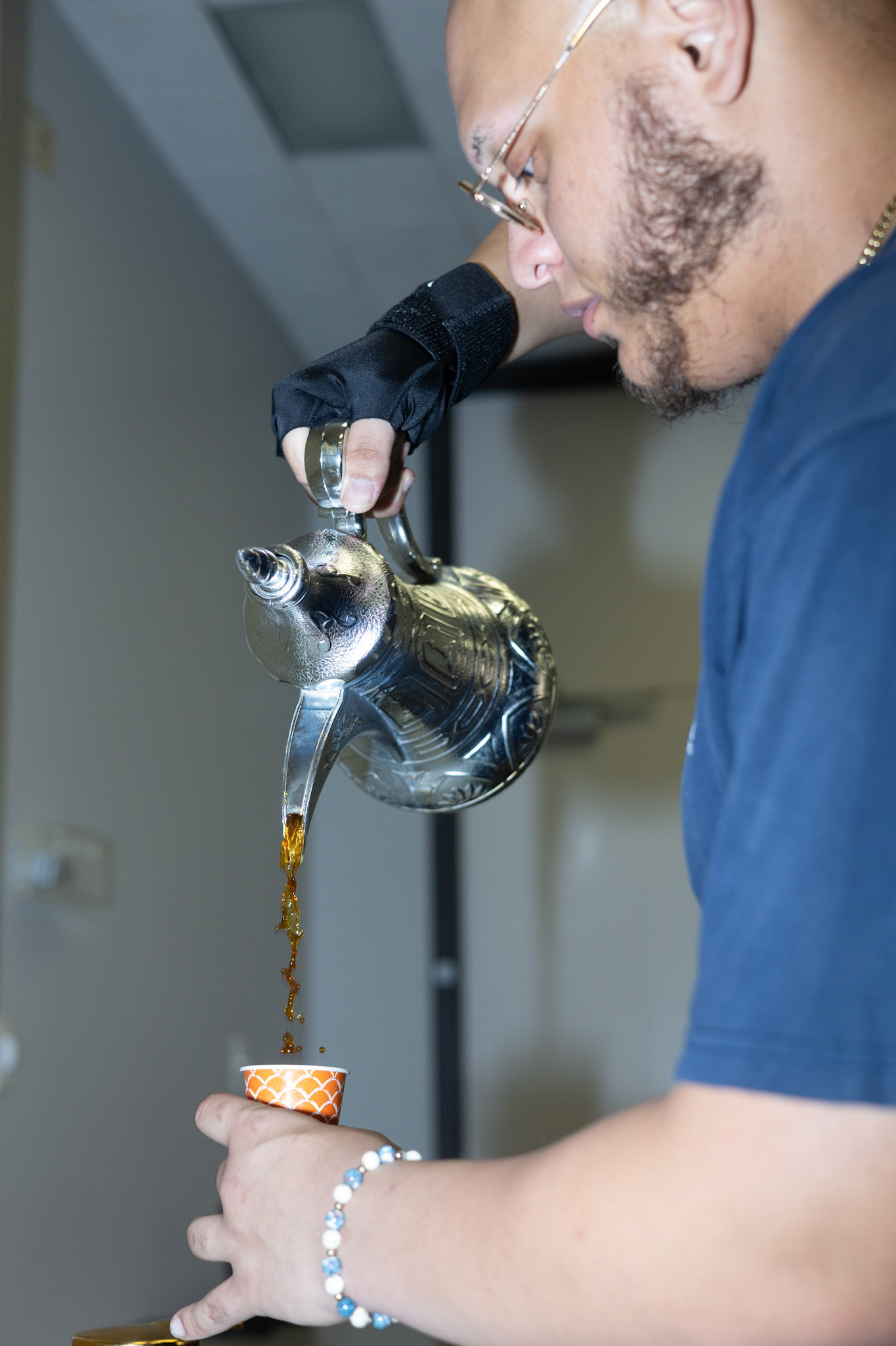 Mohammed Zakzok makes Arabic coffee for the PSC’s annual Israeli Apartheid Week art walk on April 5, 2024.