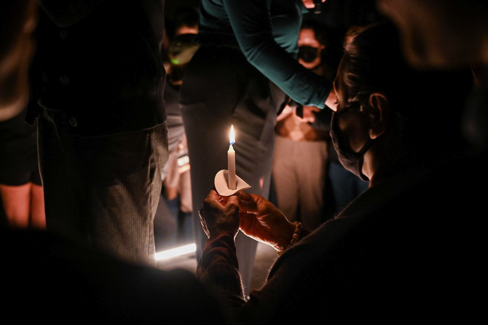 An attendee holds a candle during the candle lighting at the Beto O'Rourke rally on Feb. 9, 2022. Attendees held candles in honor of the 246 lives lost during Storm Uri in Feb. 2021.  