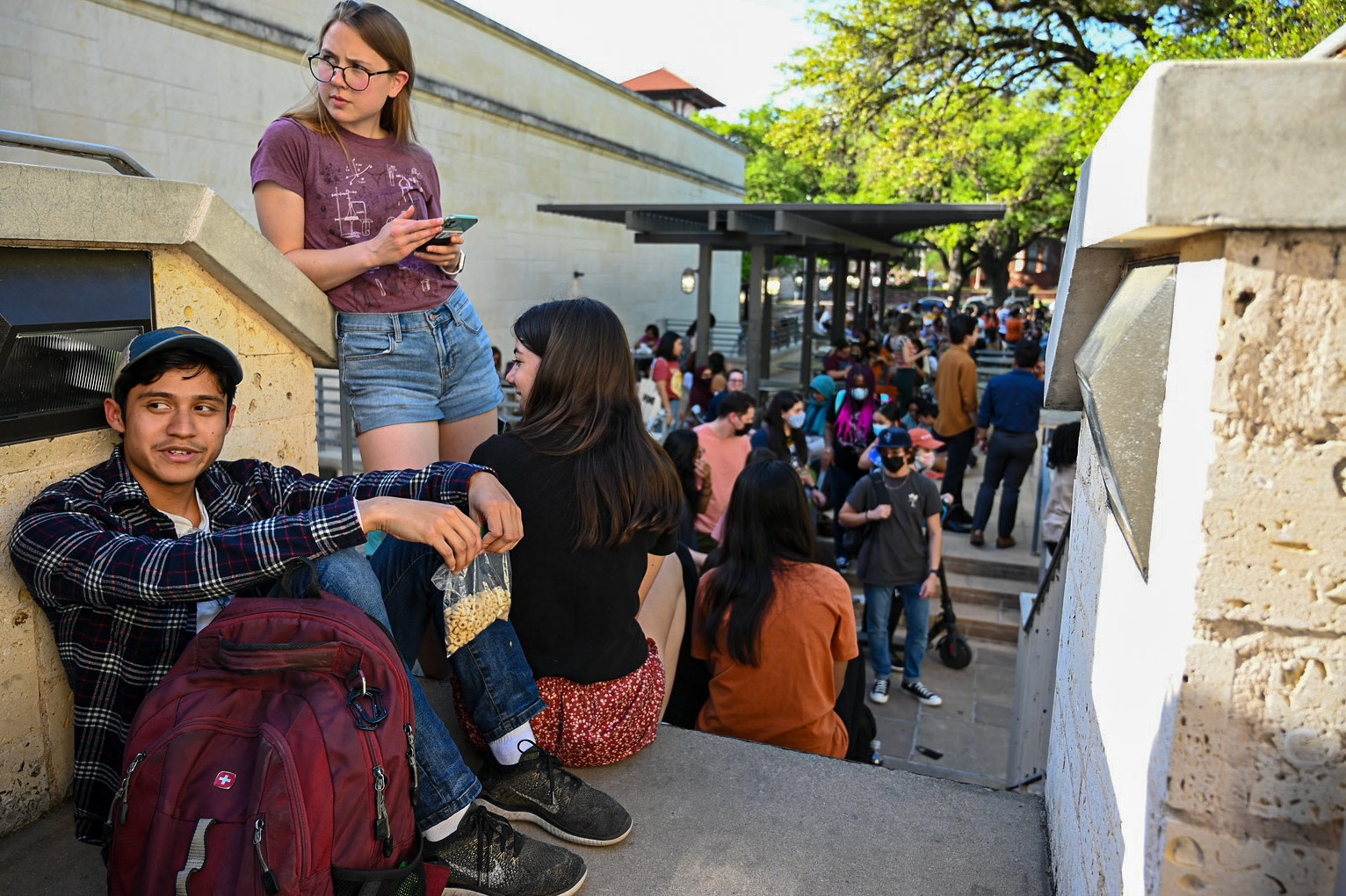 Students socialize, eat and do homework while waiting in line for Hank Green. Green creates educational science content on YouTube and TikTok, hosts several podcasts and co-created VidCon.  