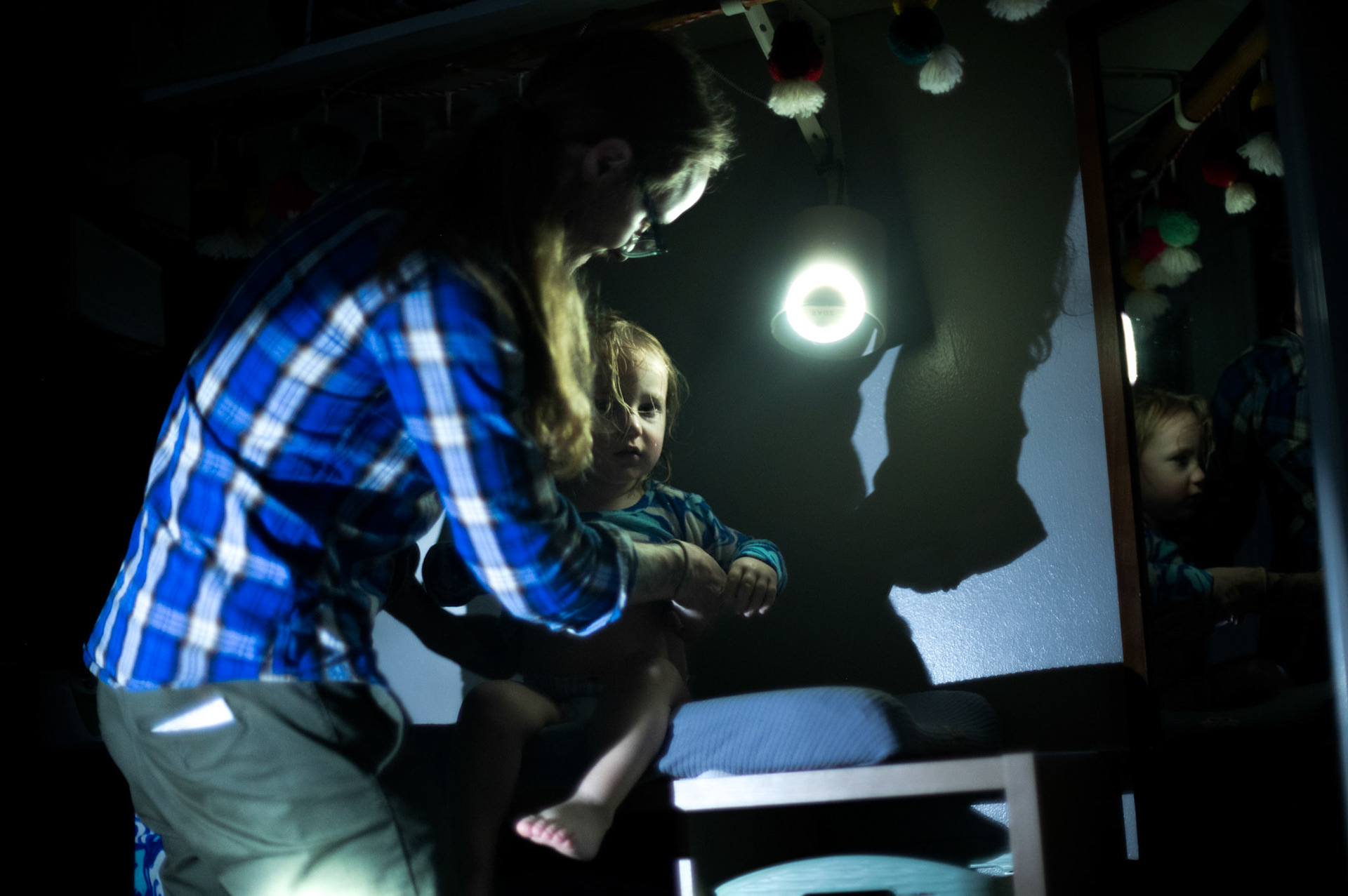 After a bath, Nick Morrow changes Shelby, 2, into pajamas for bed on Feb. 6, 2023. Shelby’s nightlight is a small LED candle.