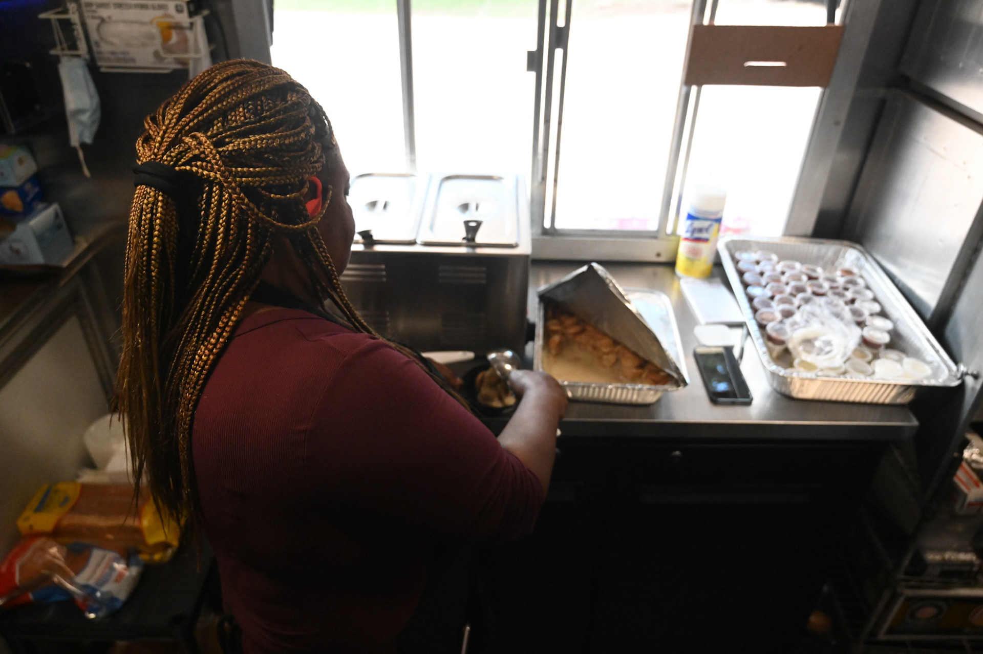 Glenda King serves banana pudding at Cedar Pork.  Shot for Community Impact.