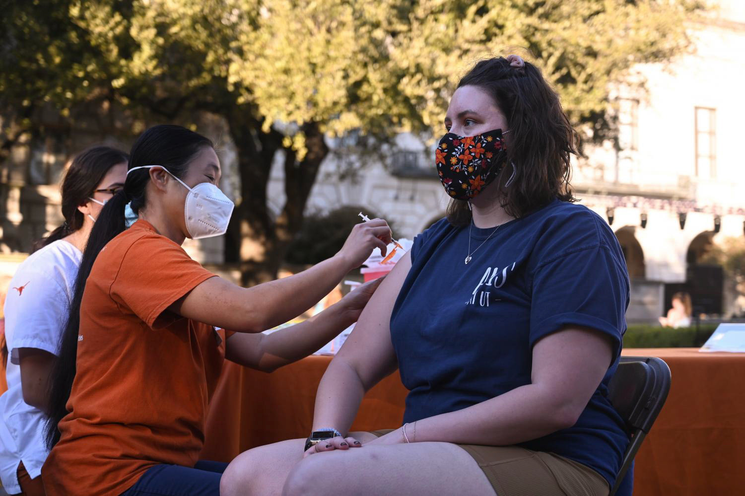 Christy Hjorth, a biochemistry graduate student who worked on protein expression and purification for HexaPro, receives her booster shot at the pop-up clinic held at the UT Tower main mall on November 18, 2021.  “It was incredibly rewarding working on it,” Hjorth said. “A lot of long hours and effort going into stuff, but it was really great seeing the translation from the bench to what is now going into all the health clinics.” 