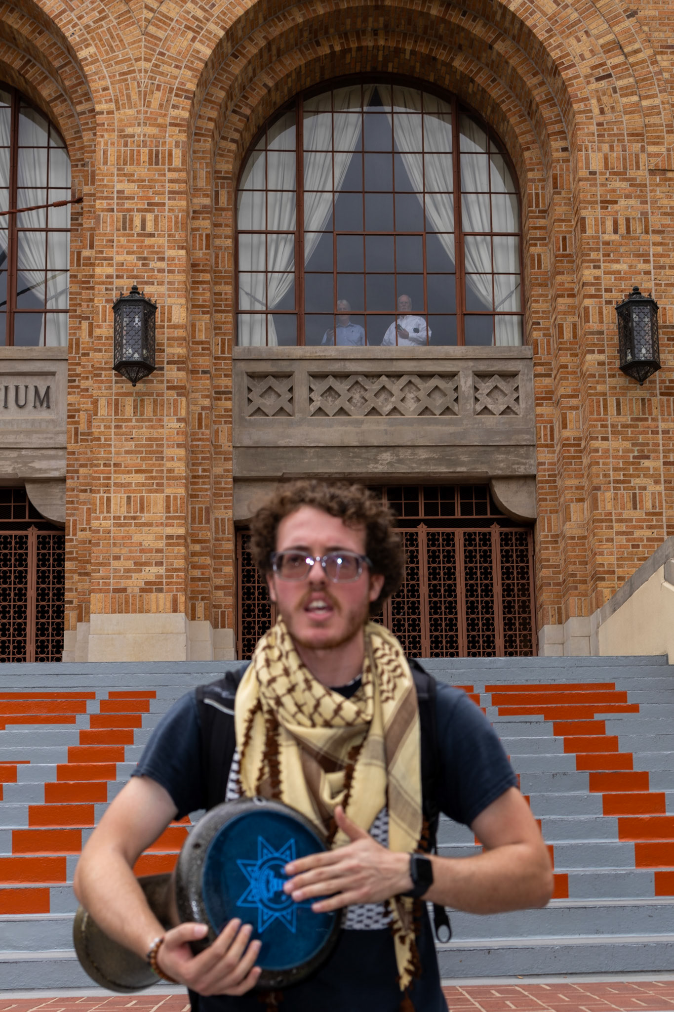 PSC organizer Ammer Qaddumi drums as a crowd gathers on the UT Gregory Gym plaza on April 24, 2024.