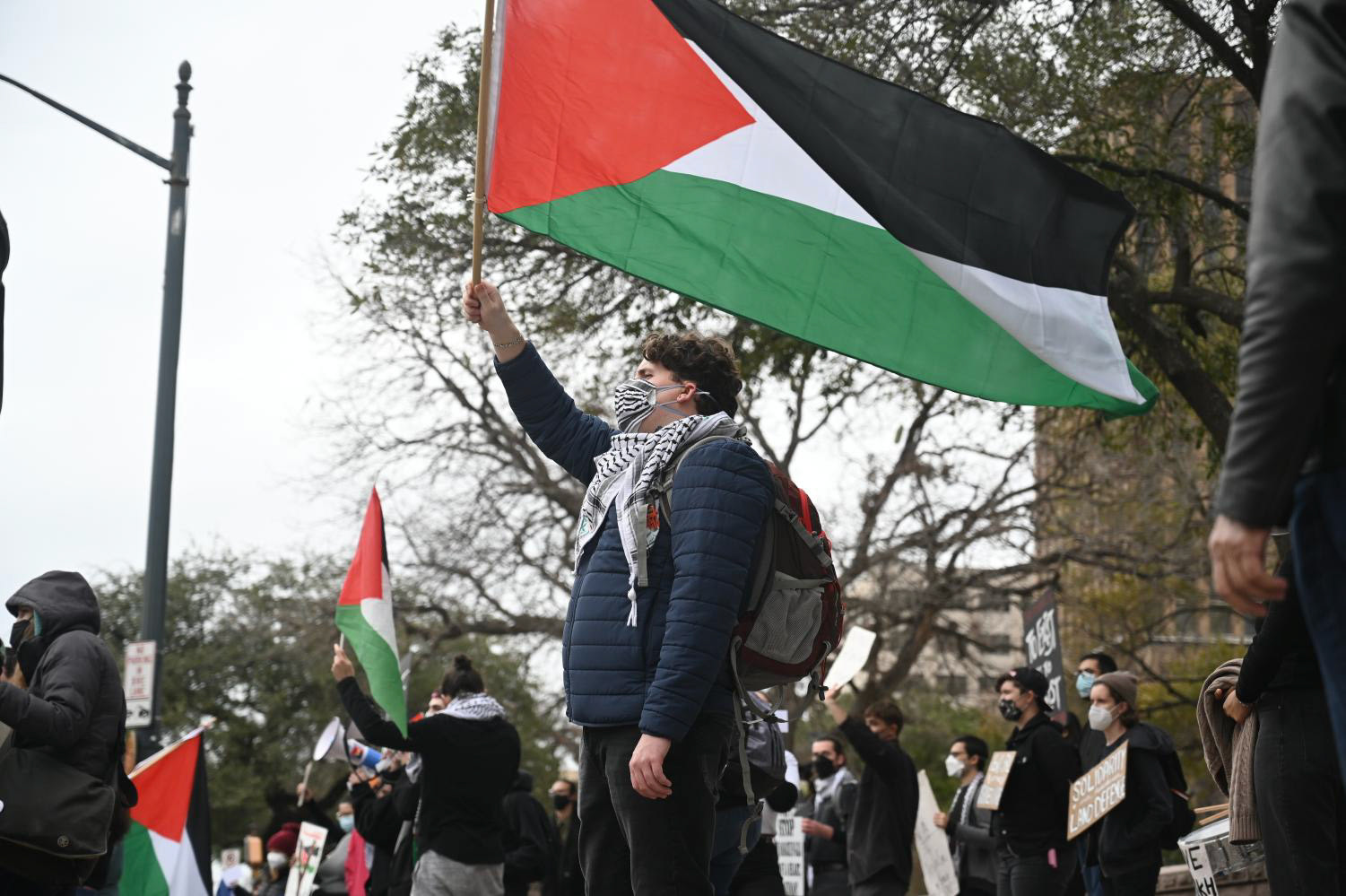 Nearly 50 UT students and community members gathered in front of the Texas capitol afternoon to protest the occupation of Palestine on January 24, 2022. Student organization Palestine Solidarity Committee held the protest at the intersection of W. 11 St. and Congress Ave., and attendees included former Palestinian residents. Protestors chanted in English and Arabic and held signs reading “Save Sheikh Jarrah” and “We Will Remain.”.  