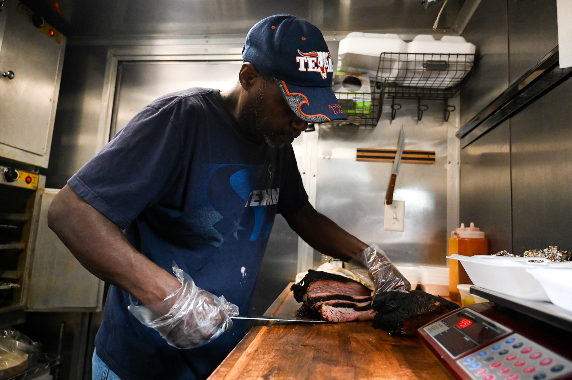 Pitmaster Orie King serves up a brisket platter at OG’s Barbeque at the Cedar Pork food truck park. Shot for Community Impact.