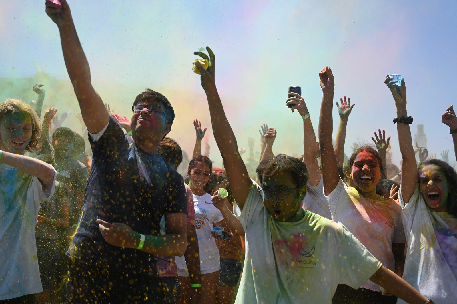 Holi Fest attendees jump after the countdown to the rang powder toss on April 9, 2022. Also known as the Festival of Colors, Holi is a Hindu celebration welcoming the arrival of spring.  
