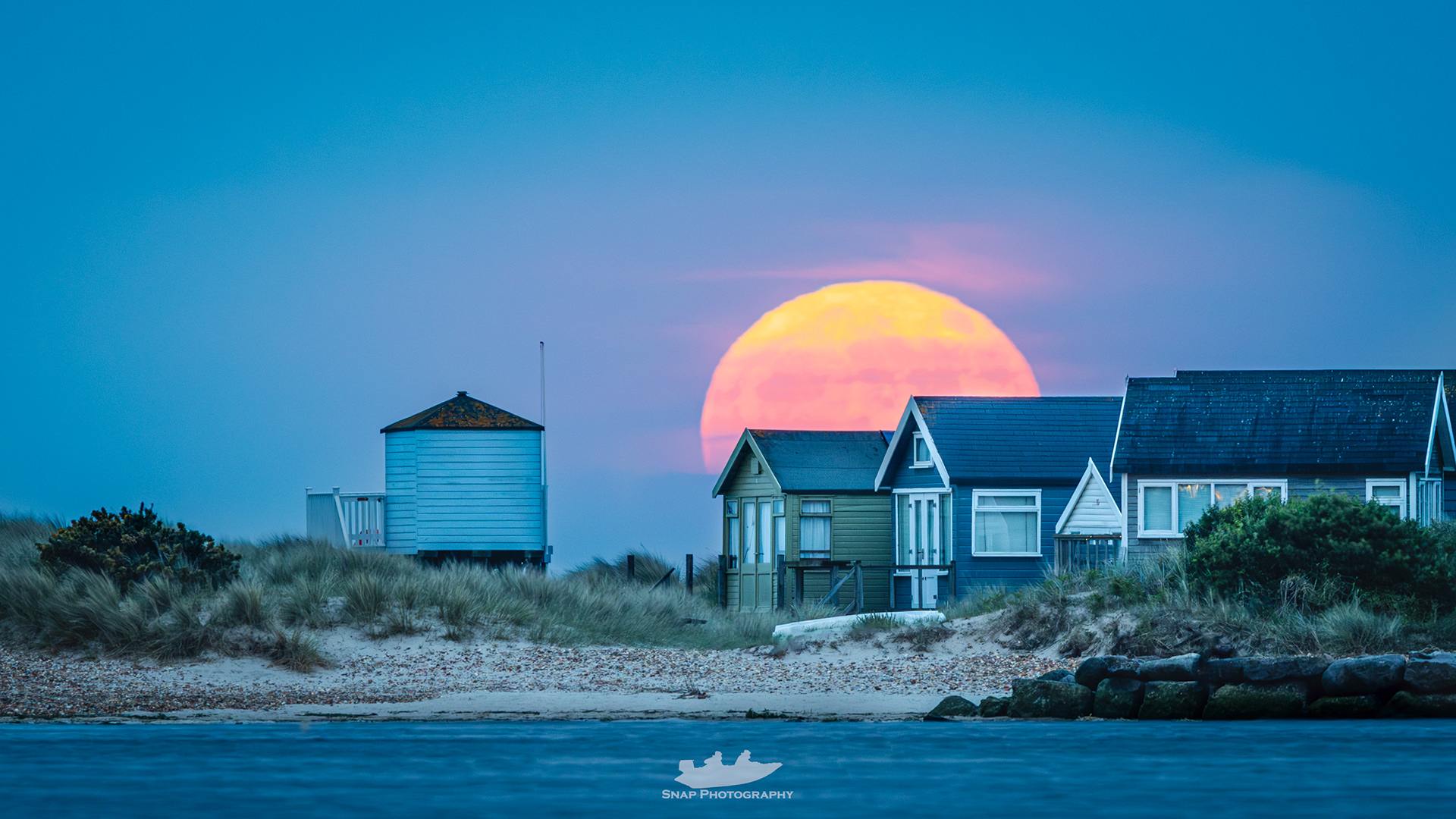 Moon rise over the beach huts on Mudeford sandbank