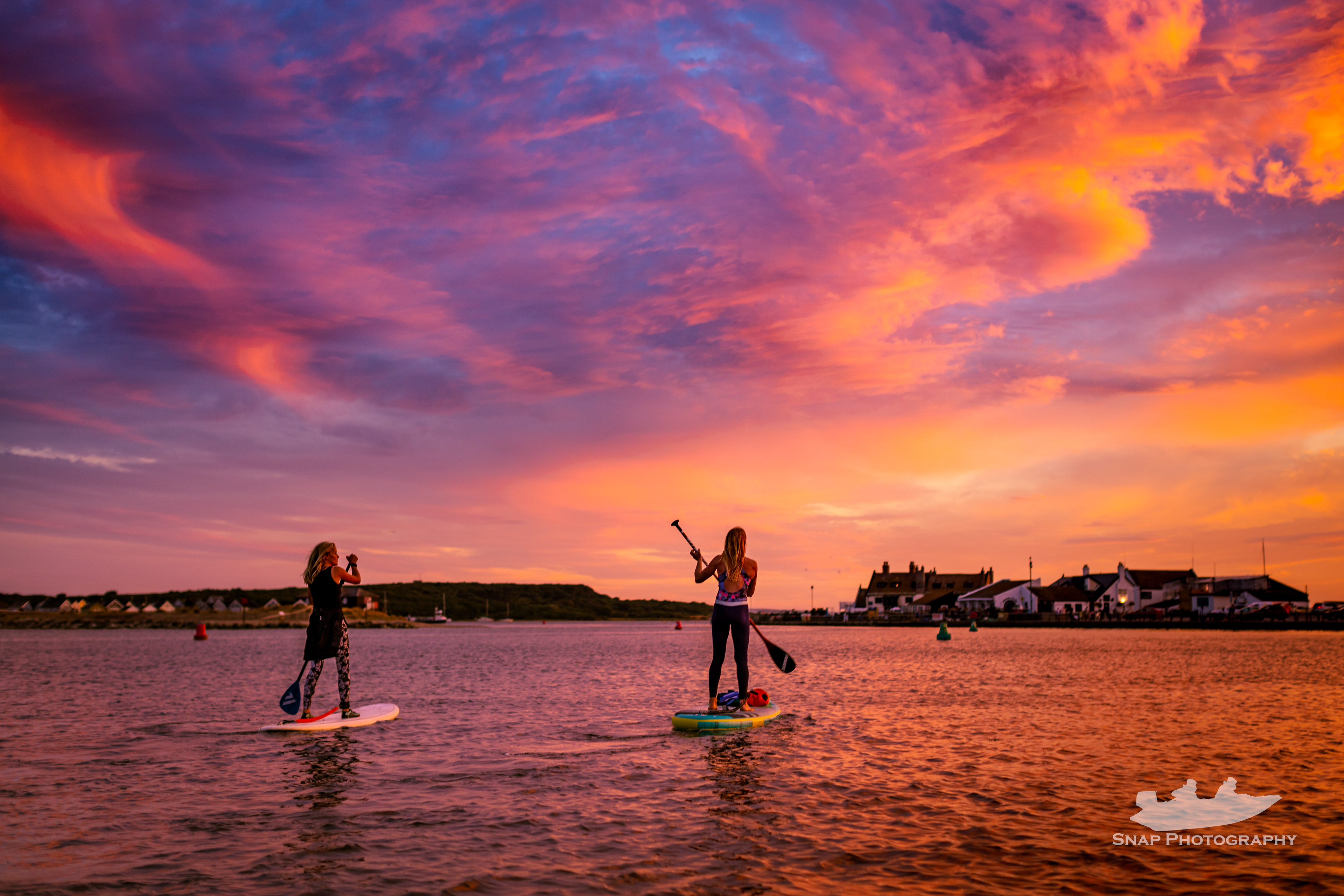 Paddle boarding into the sunset at Mudeford Quay