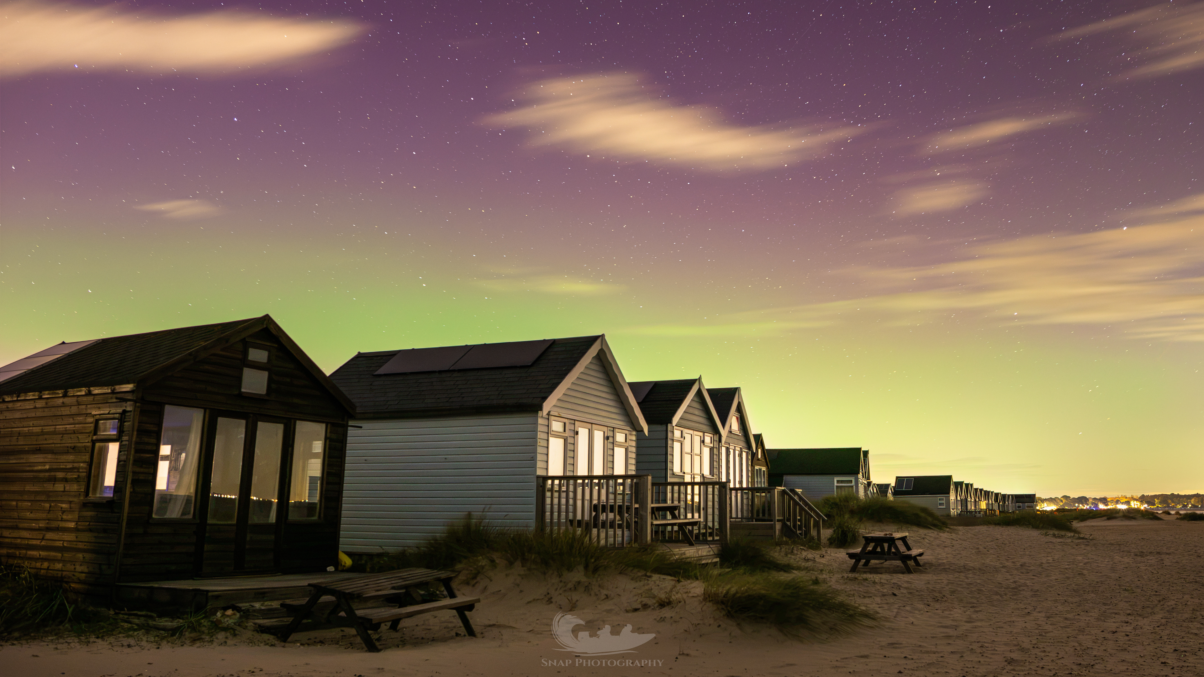 Faint aurora over Hengistbury Head beach huts