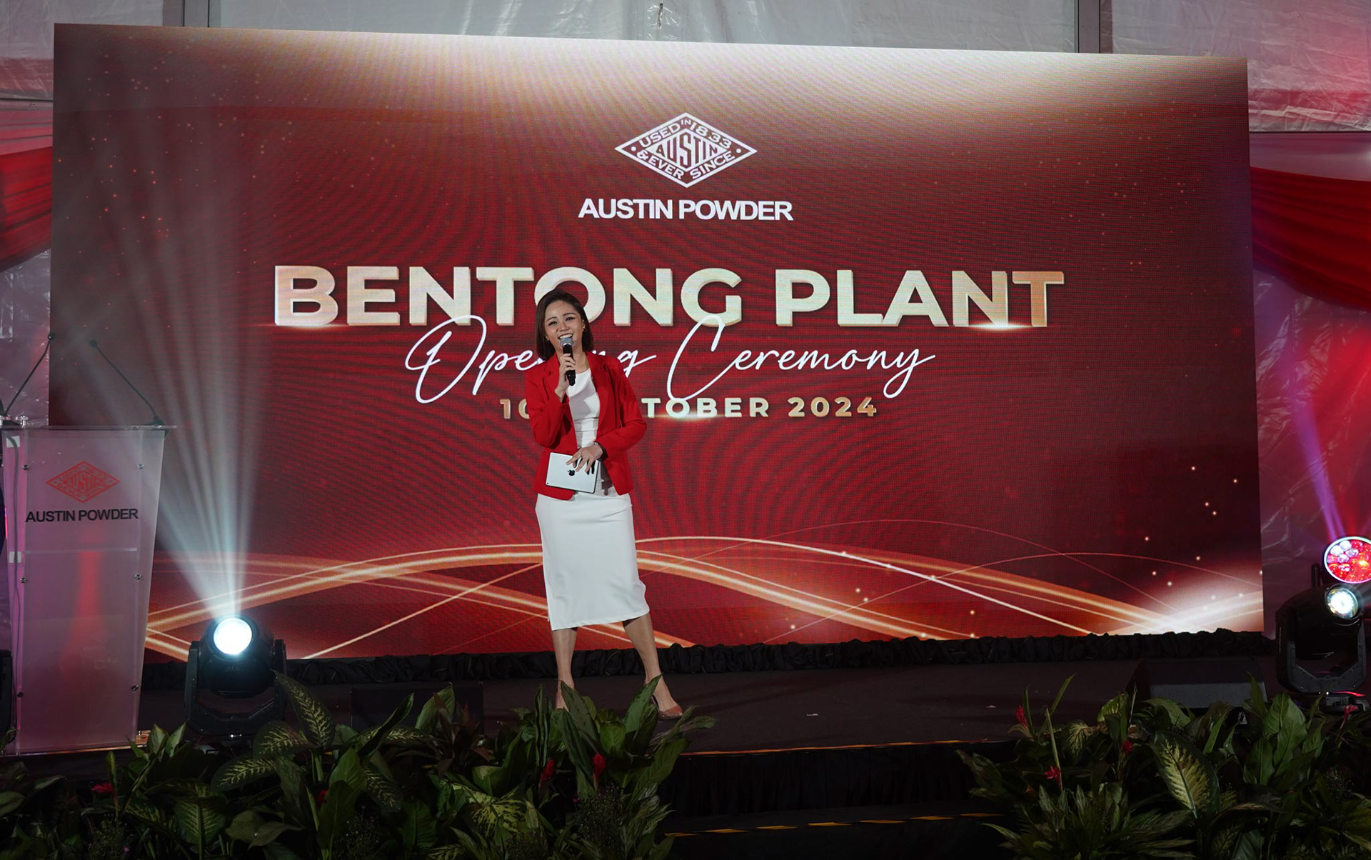 Professional event host delivering a speech at a grand opening celebration
