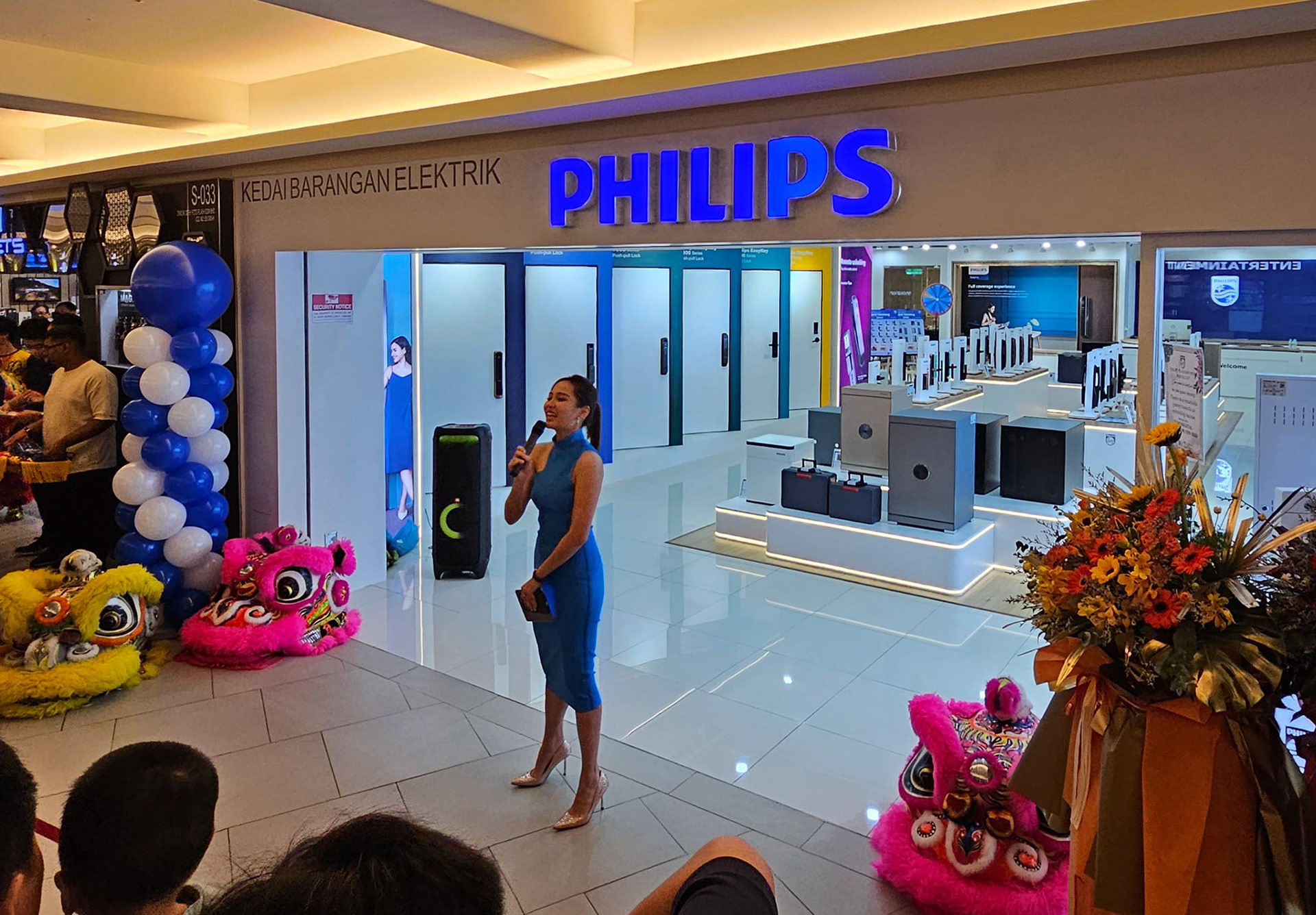 Dynamic emcee leading a grand opening event with ribbon cutting and excited guests