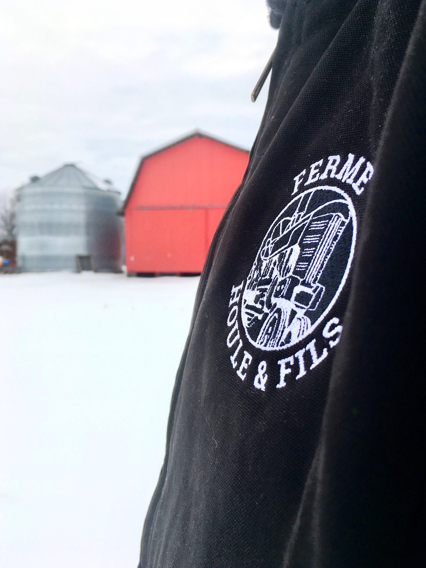 Ferme Houle & Fils logo printed on a jacket.