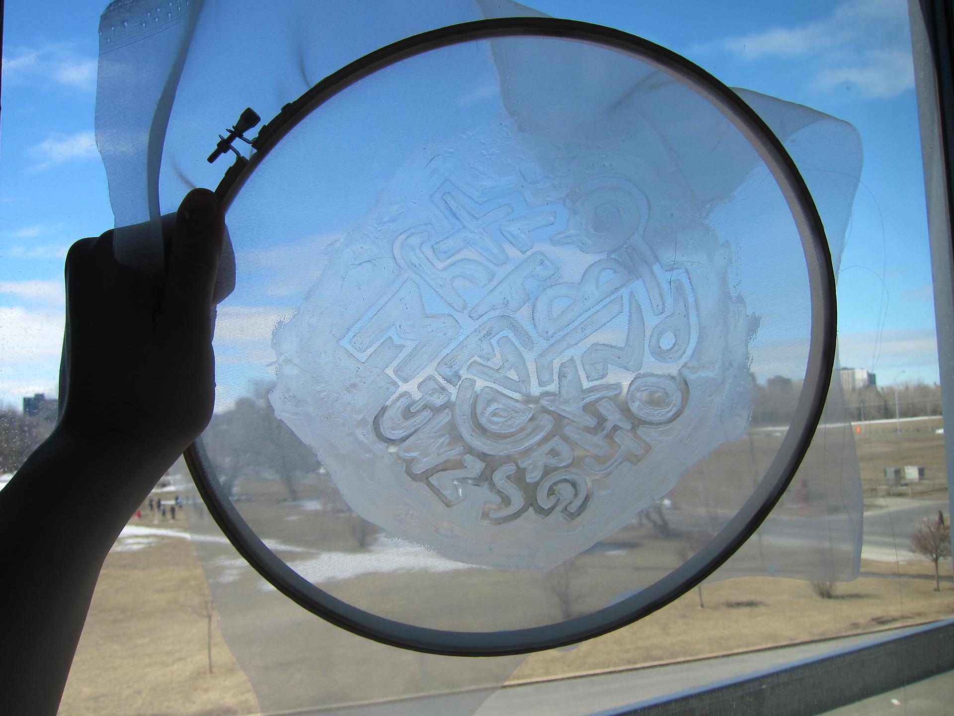 Outlining the traced design with Mod Podge to seal it from the ink