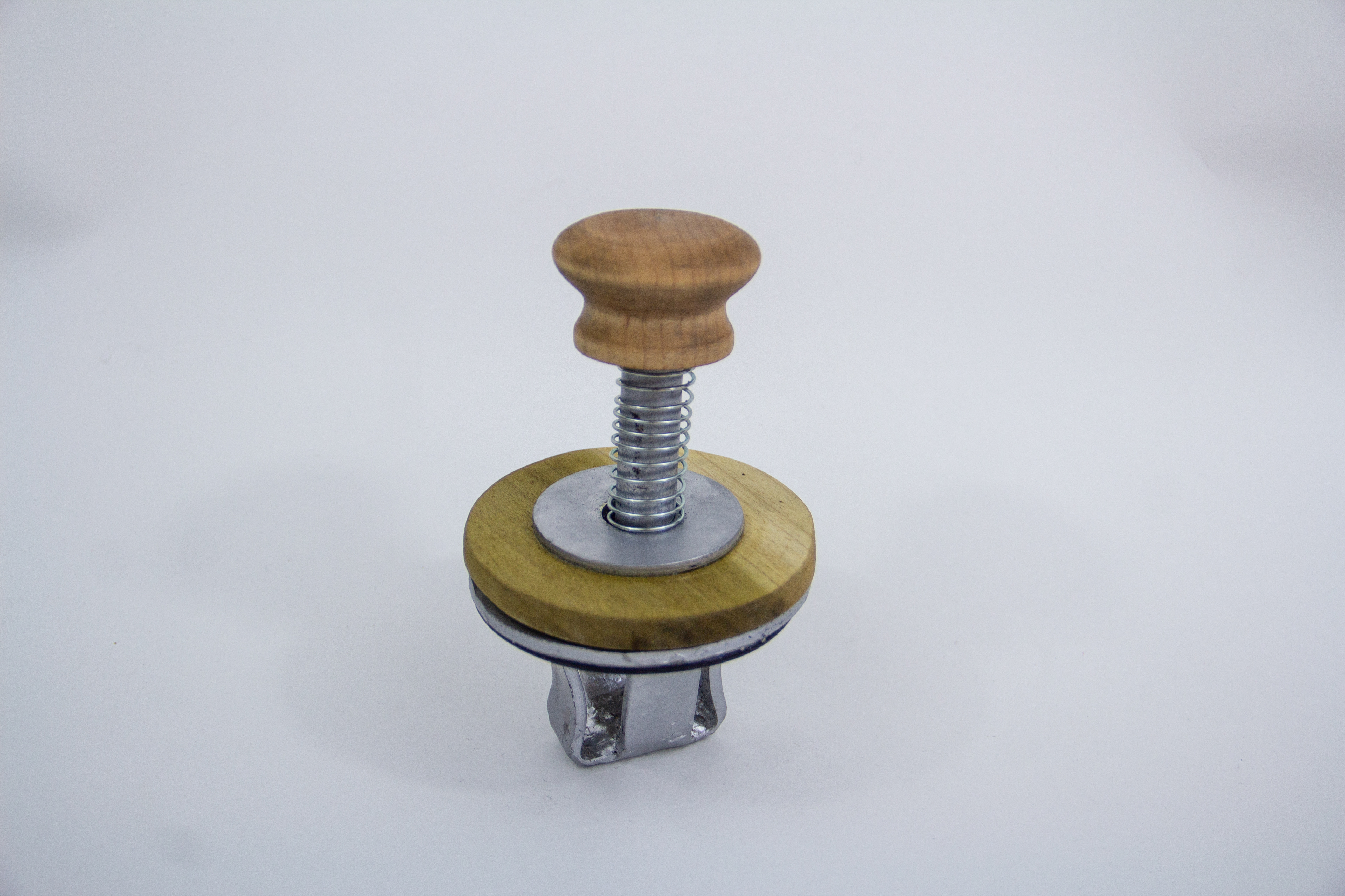 Walnut cracker top mechanism with basket and pin.