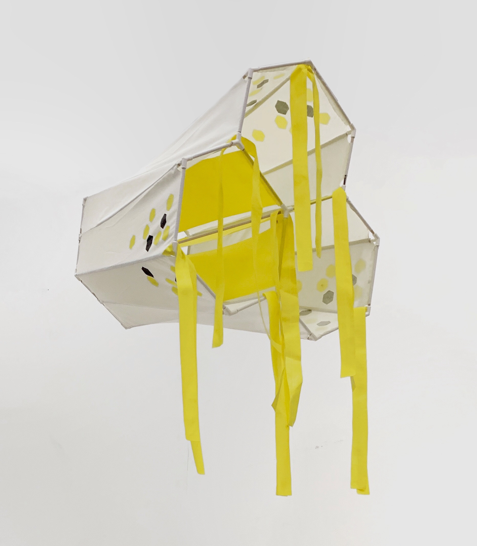 View of the back of the kite as it hands, suspended from the ceiling.