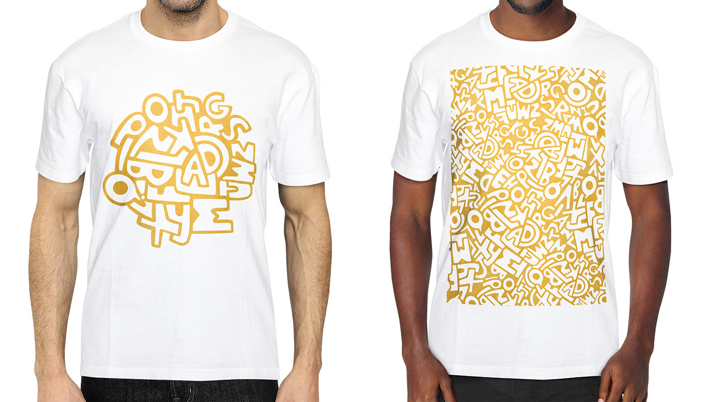 Two people are wearing white t-shirts with the Alphabet Soup design printed on them. The person on the left is wearing the initial doodle with one of each letter in the alphabet. The person on the right is wearing a t-shirt with the evolved pattern on it, which covers the whole front of the t-shirt.