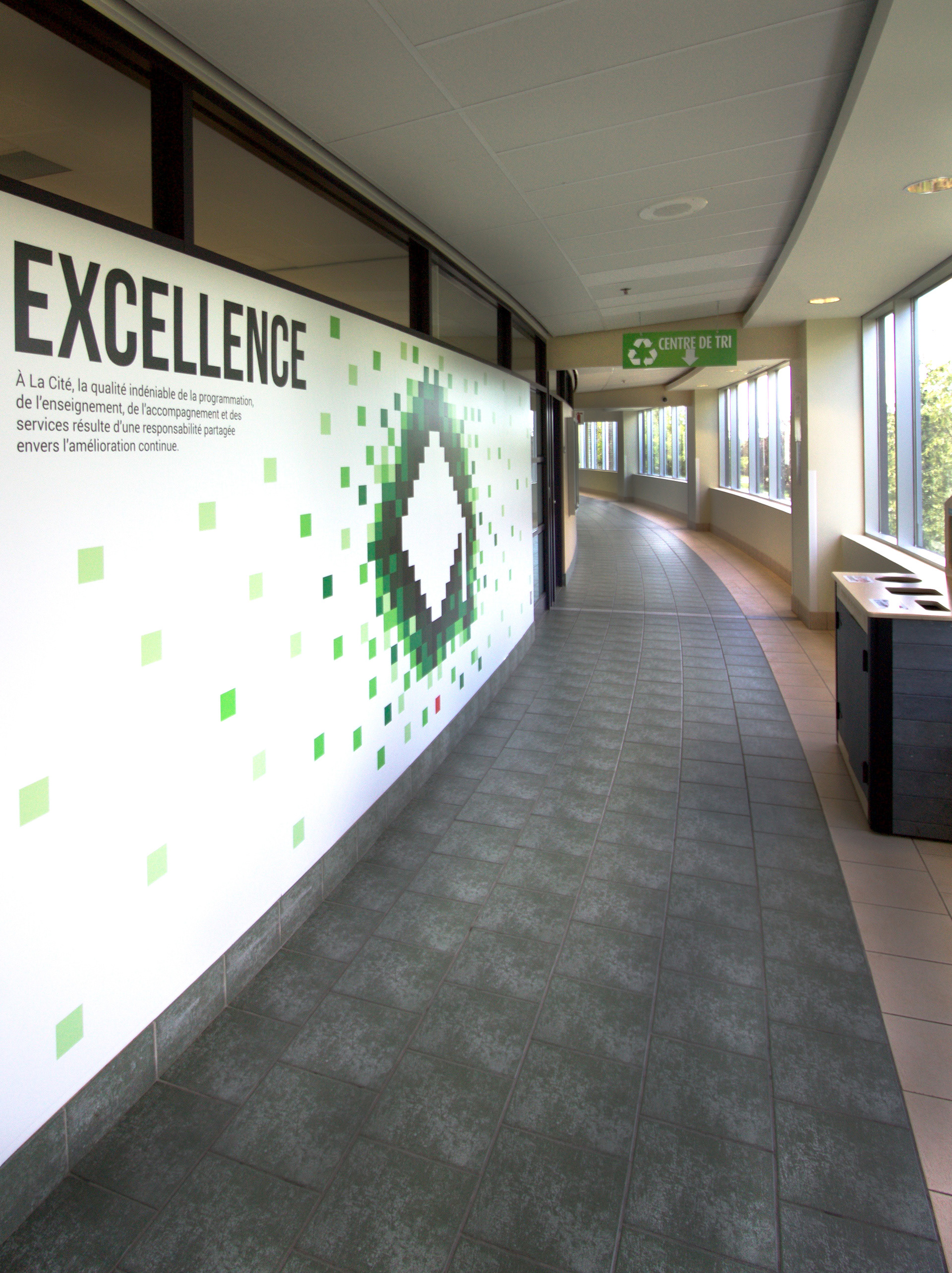 Excellence vinyl on a wall in a hallway.