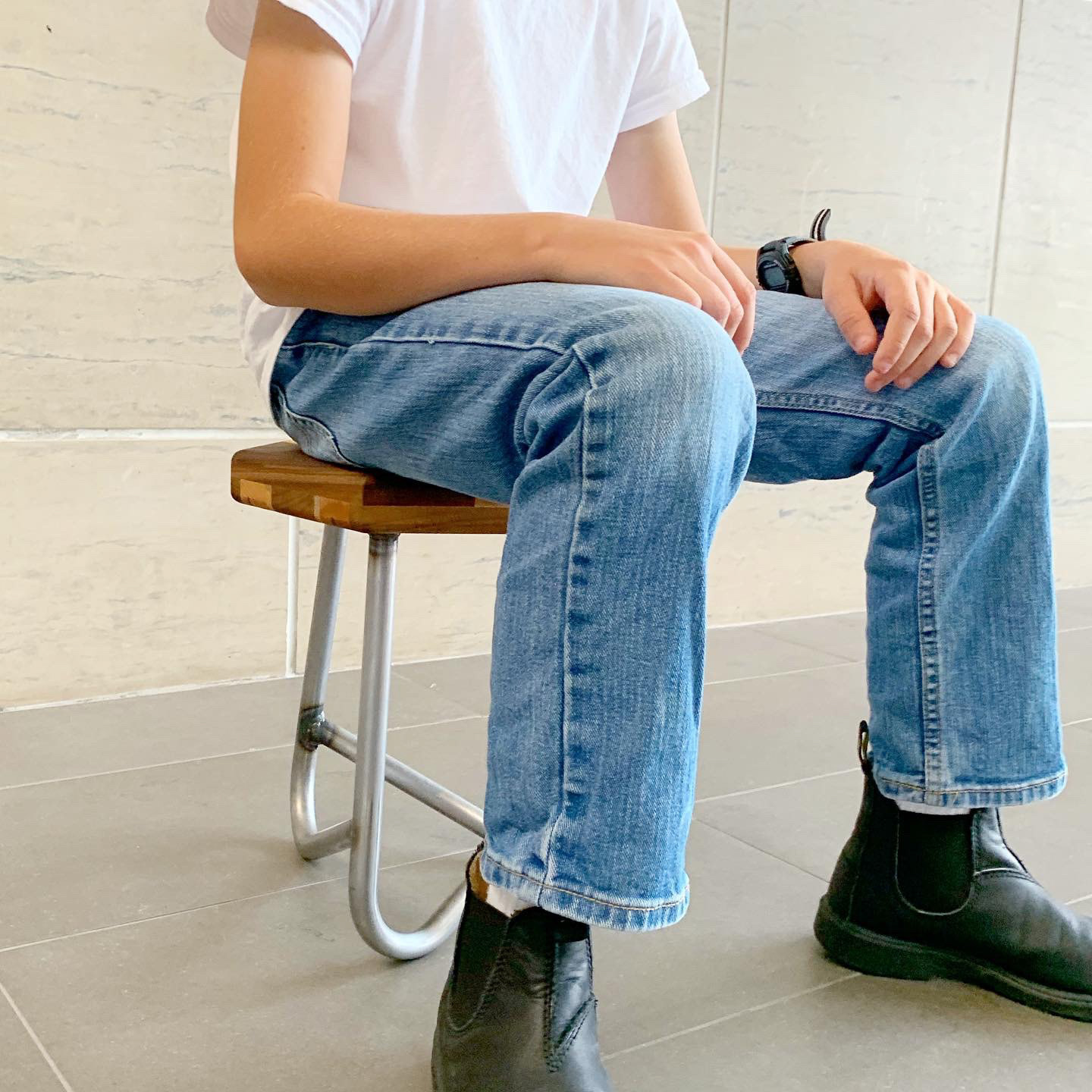 A child sits on the stool.