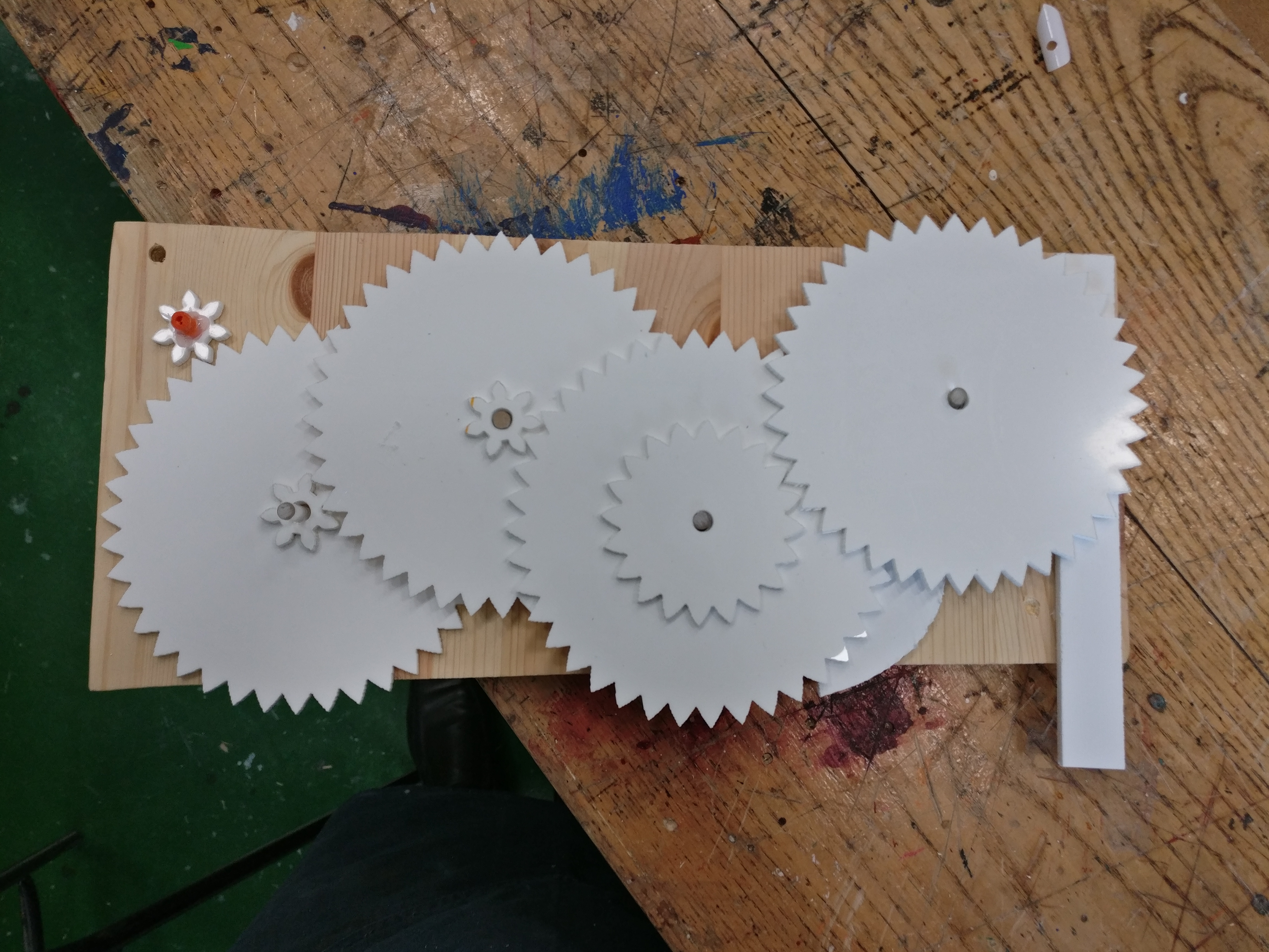 Using an online gear generator, I got a gear layout and laser cut it out of acrylic