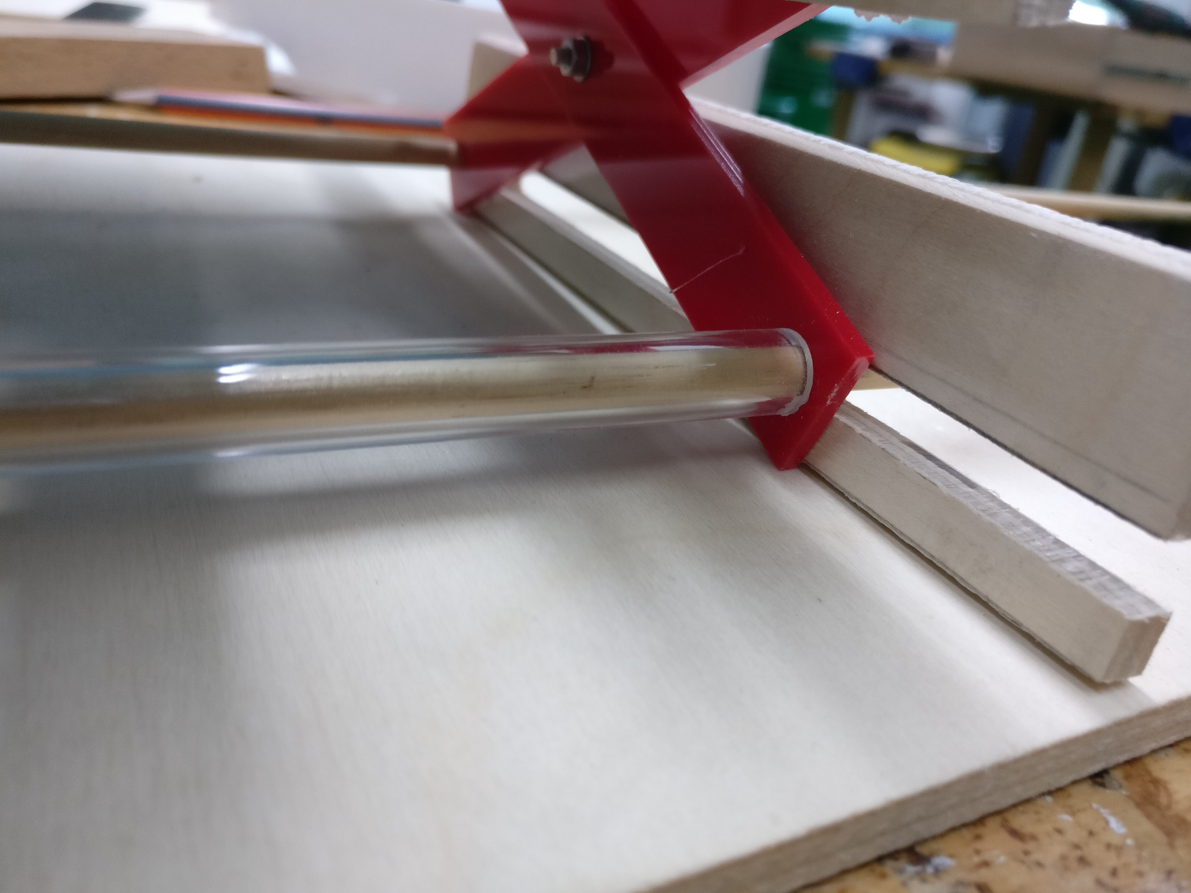 Used stronger crossbar dowels within an acrylic tube to keep the mechanism straight