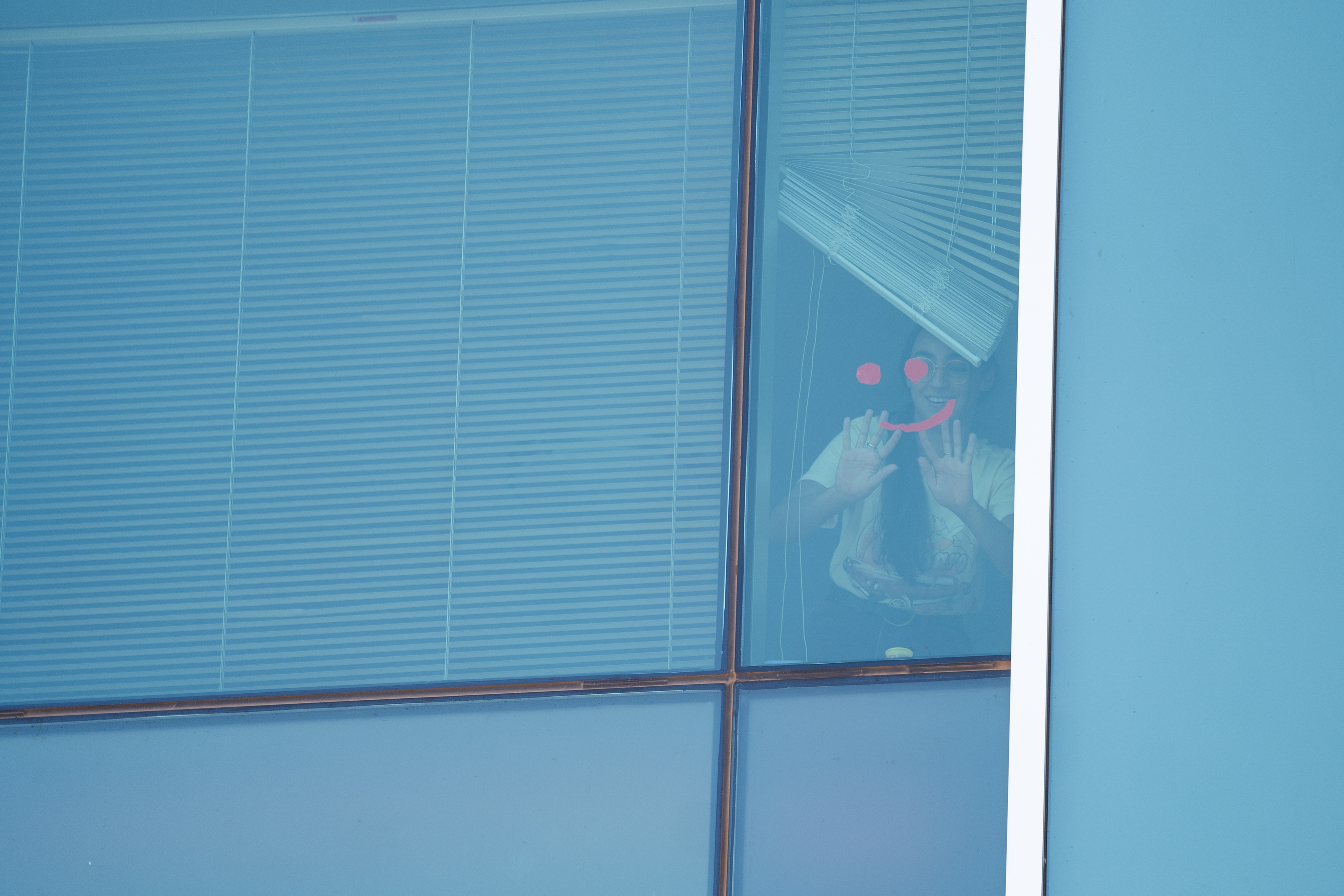 Nicole Parascandola uses Play-Doh to make a smile in her dorm room window at Taylor Place on Sept. 16, 2020. (Samantha Chow/State Press)