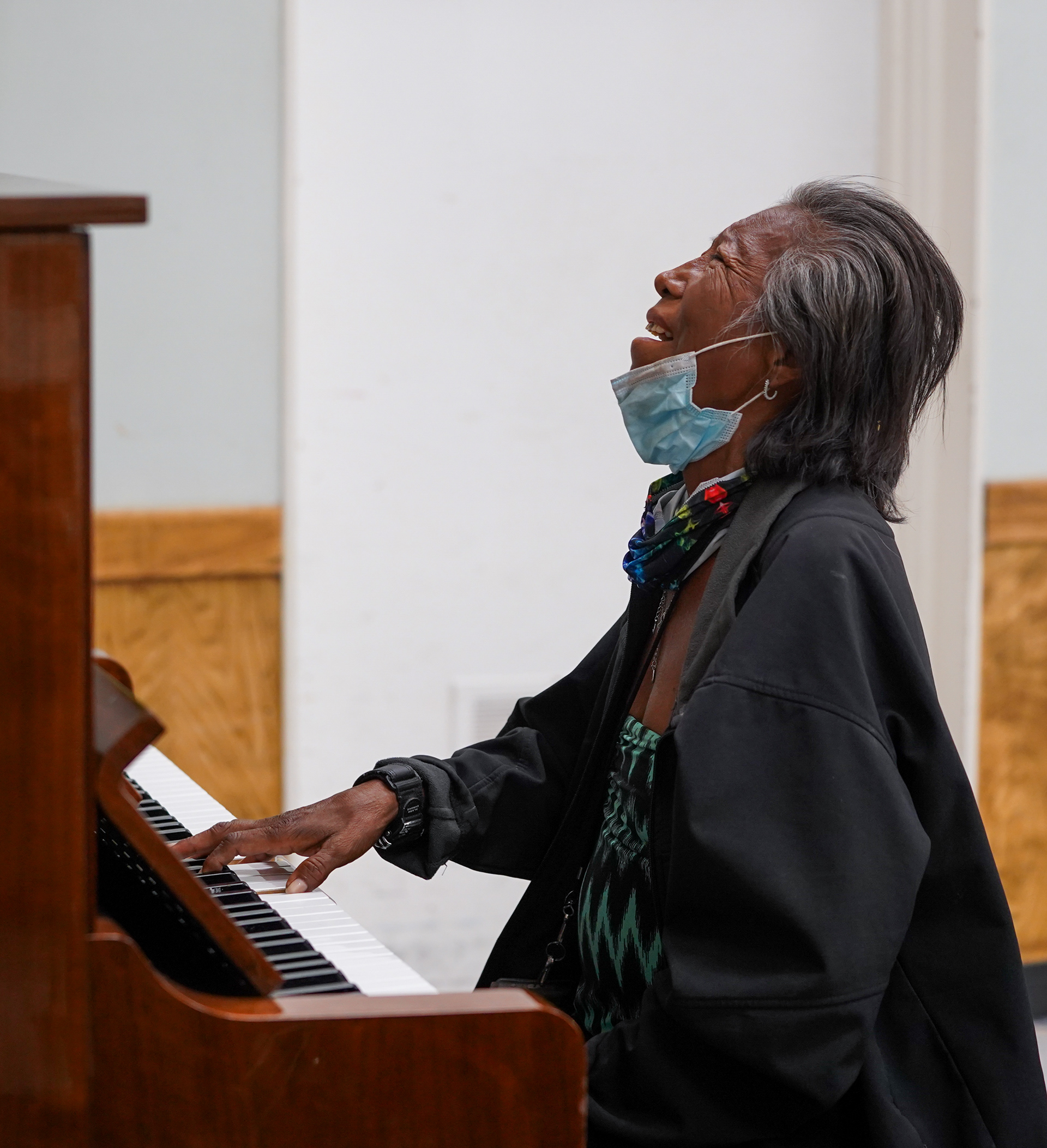 Barbara Fuller, a woman experiencing homelessness, plays the piano at Grace Lutheran Church in downtown Phoenix on April 11, 2021. Despite suffering from arthritis, she said one of her greatest desires is to have a room to herself where she can play the piano all day. (Photo by Samantha Chow/State Press)