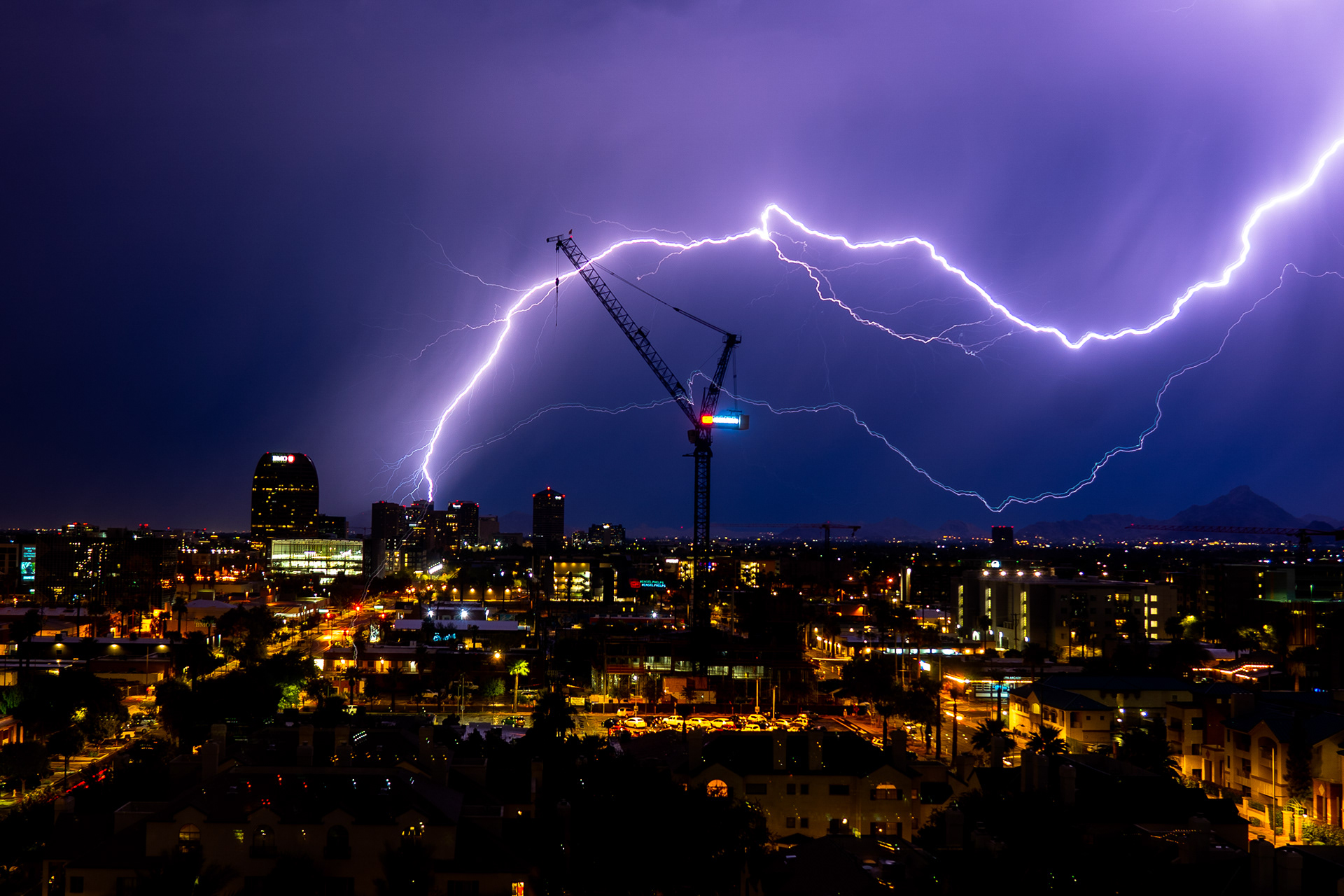 Lightning strikes over a crane in Downtown Phoenix on Aug. 20, 2020. (Samantha Chow)