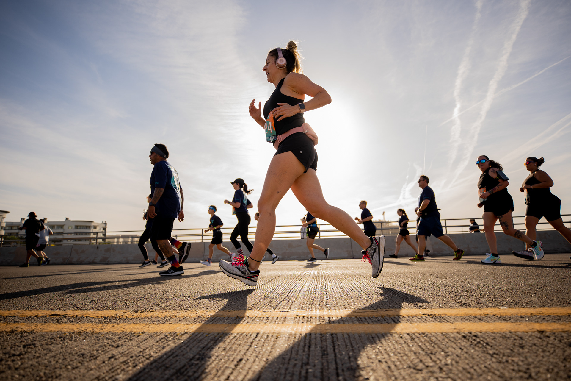 Runners cross the Tempe Town Lake Rural Road Bridge during the 18th annual Pat’s Run in Tempe on April 23, 2022. (Photo by Samantha Chow/Arizona State University)