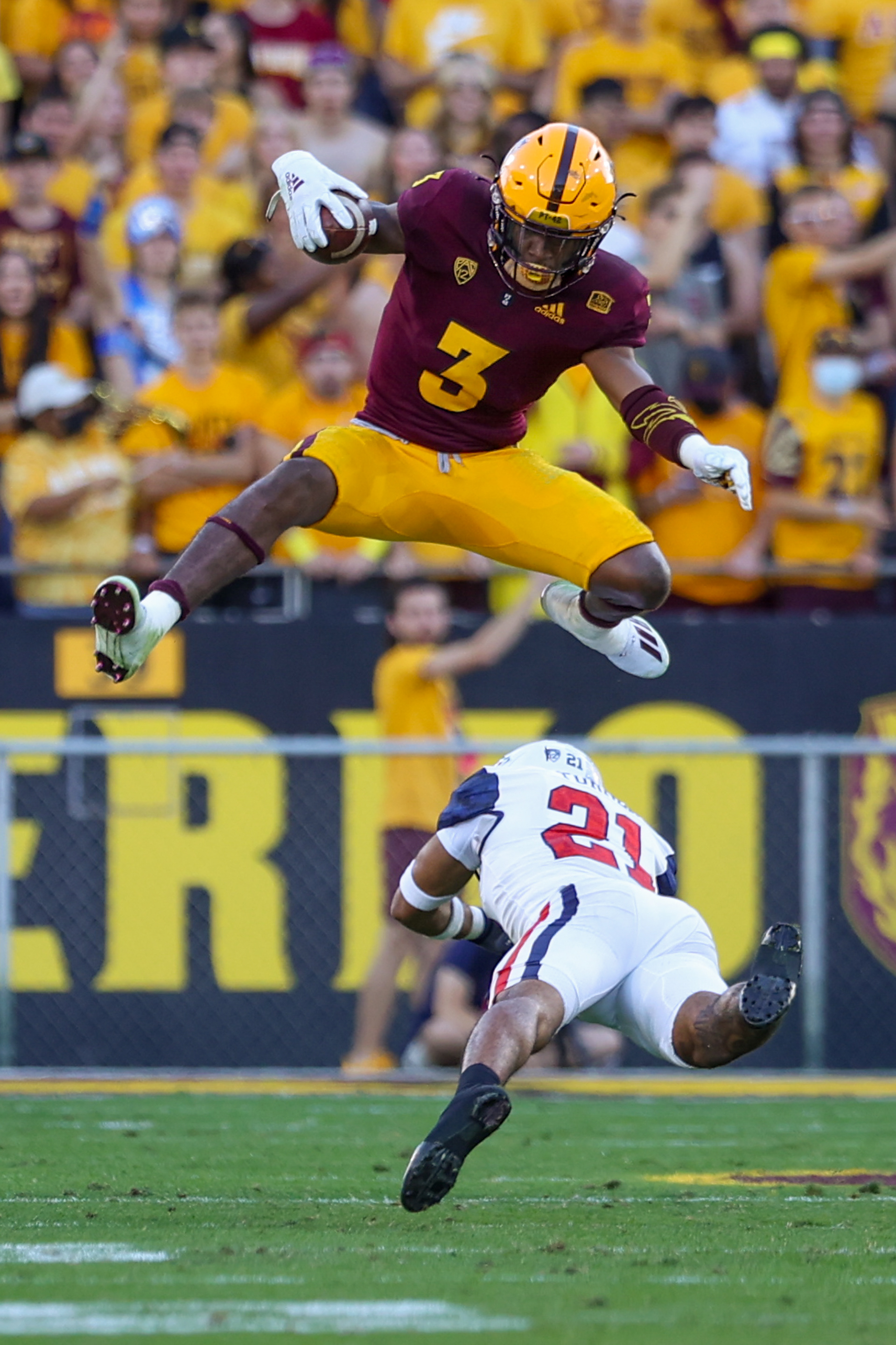 ASU redshirt senior Rachaad White (3) hurdles over UA safety Jaxen Turner (21) during the Territorial Cup game at Sun Devil Stadium in Tempe on Nov. 27, 2021. (Samantha Chow/Arizona State University)