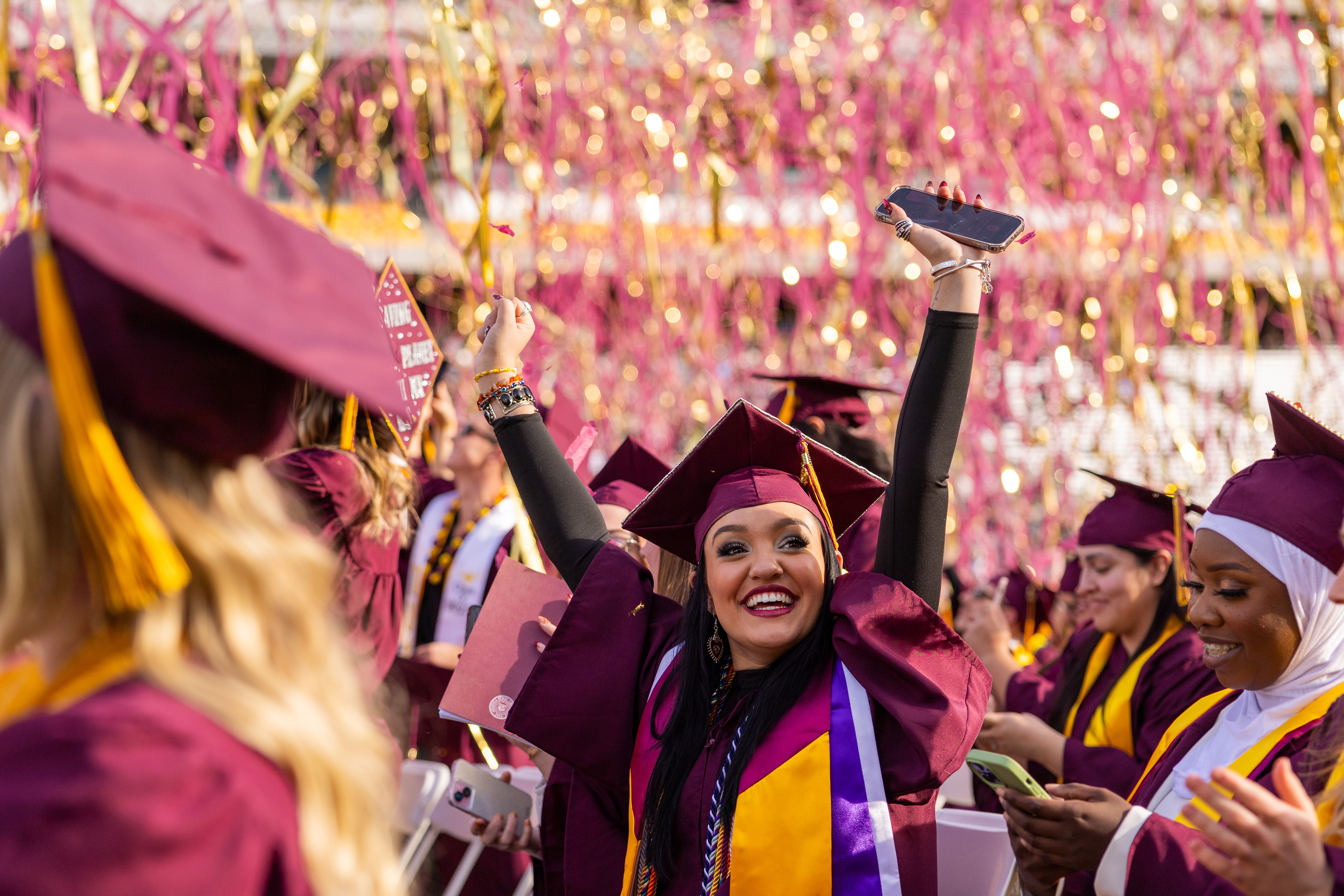 ASU nursing graduate Esperanza Biggs celebrates as the confetti goes off during undergraduate commencement at Mountain America Stadium in Tempe on Dec. 11, 2023. (Photo by Samantha Chow/Arizona State University)