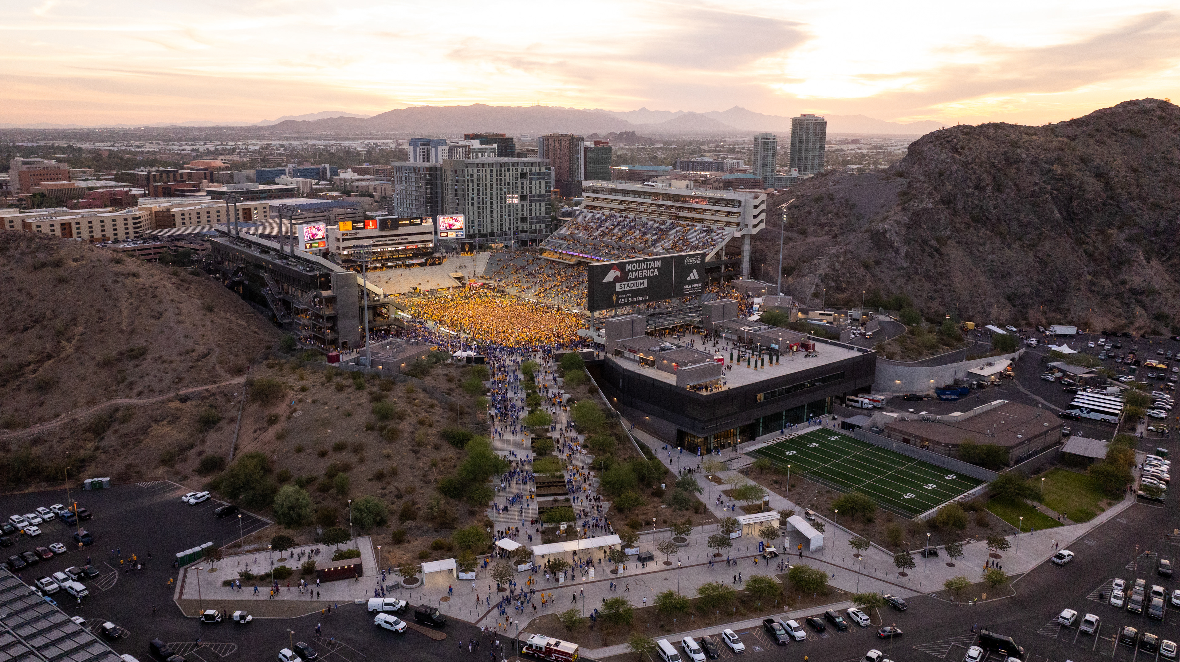 ASU football fans rush the field after upsetting BYU 28-23 at Mountain America Stadium in Tempe on Nov. 23, 2024. (Photo by Samantha Chow/Arizona State University)