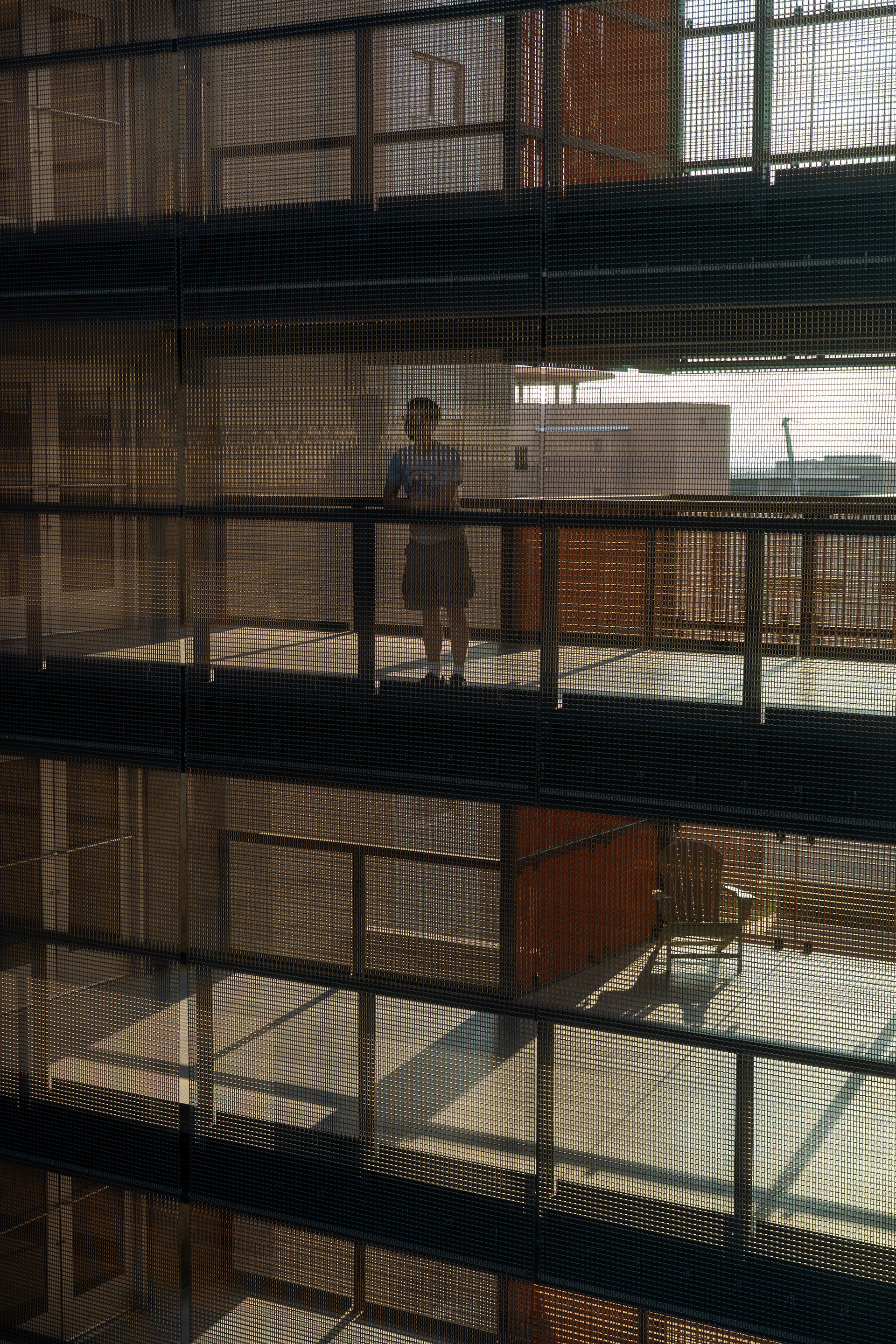 A resident looks out over the bridge at the Taylor Place dorms on Sept. 15, 2020. (Samantha Chow/State Press)