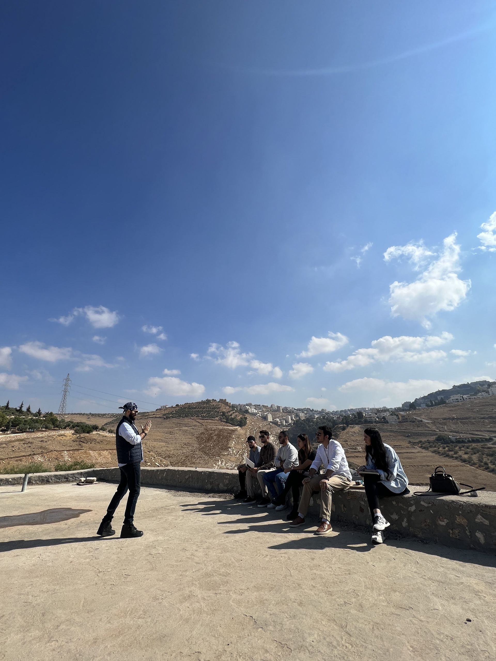 Arch. HANNA S QUBTI delivering an on-site briefing to his students on their architectural project.