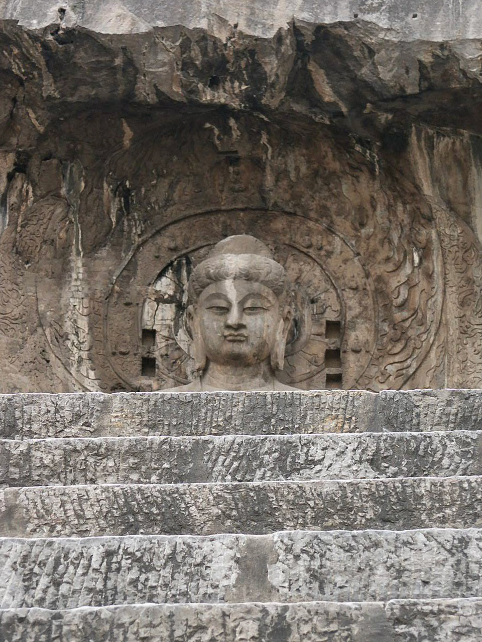 Longmen Caves contain a huge collection of Buddha statues of all sizes