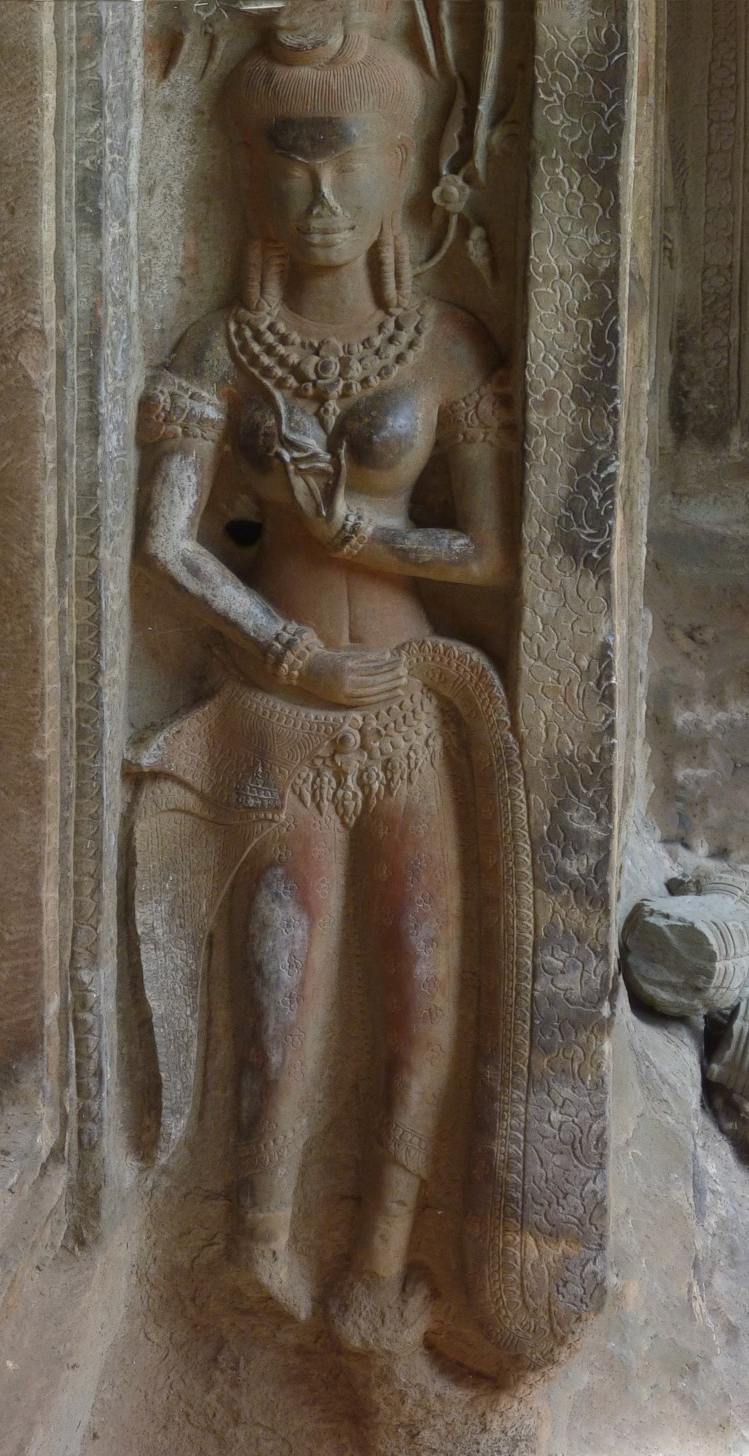 The darker areas of the statues are caused by (originally) worshippers and (lately) tourists rubbing the area for good luck (or, perhaps in this case. for other reasons).