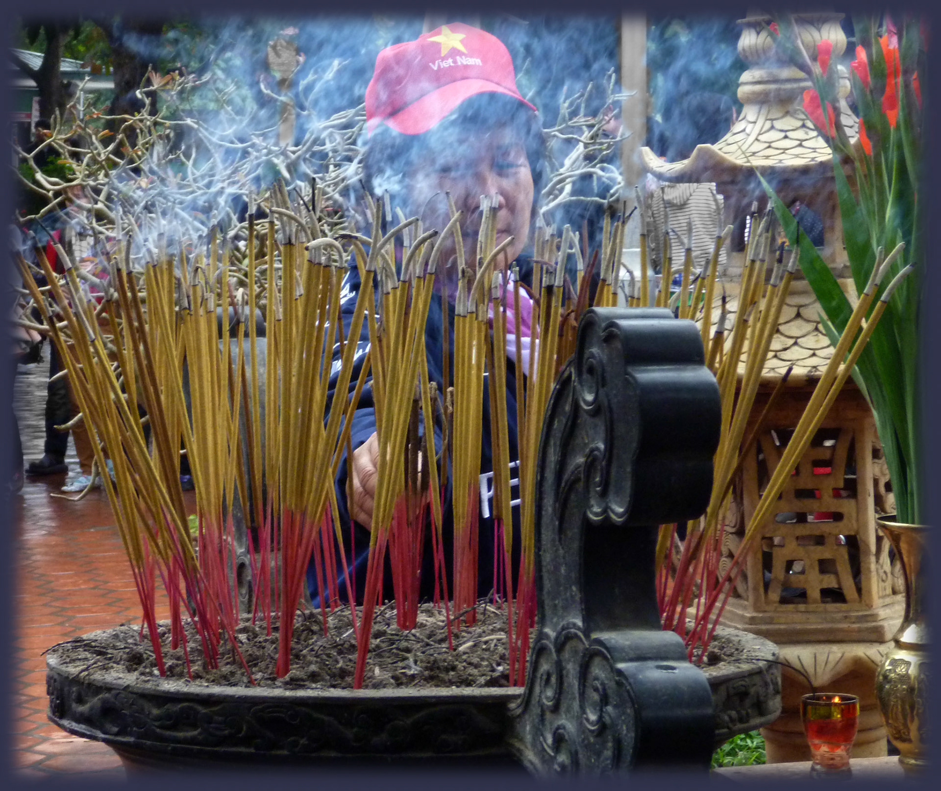 At prayer near the One Pillar Pagoda