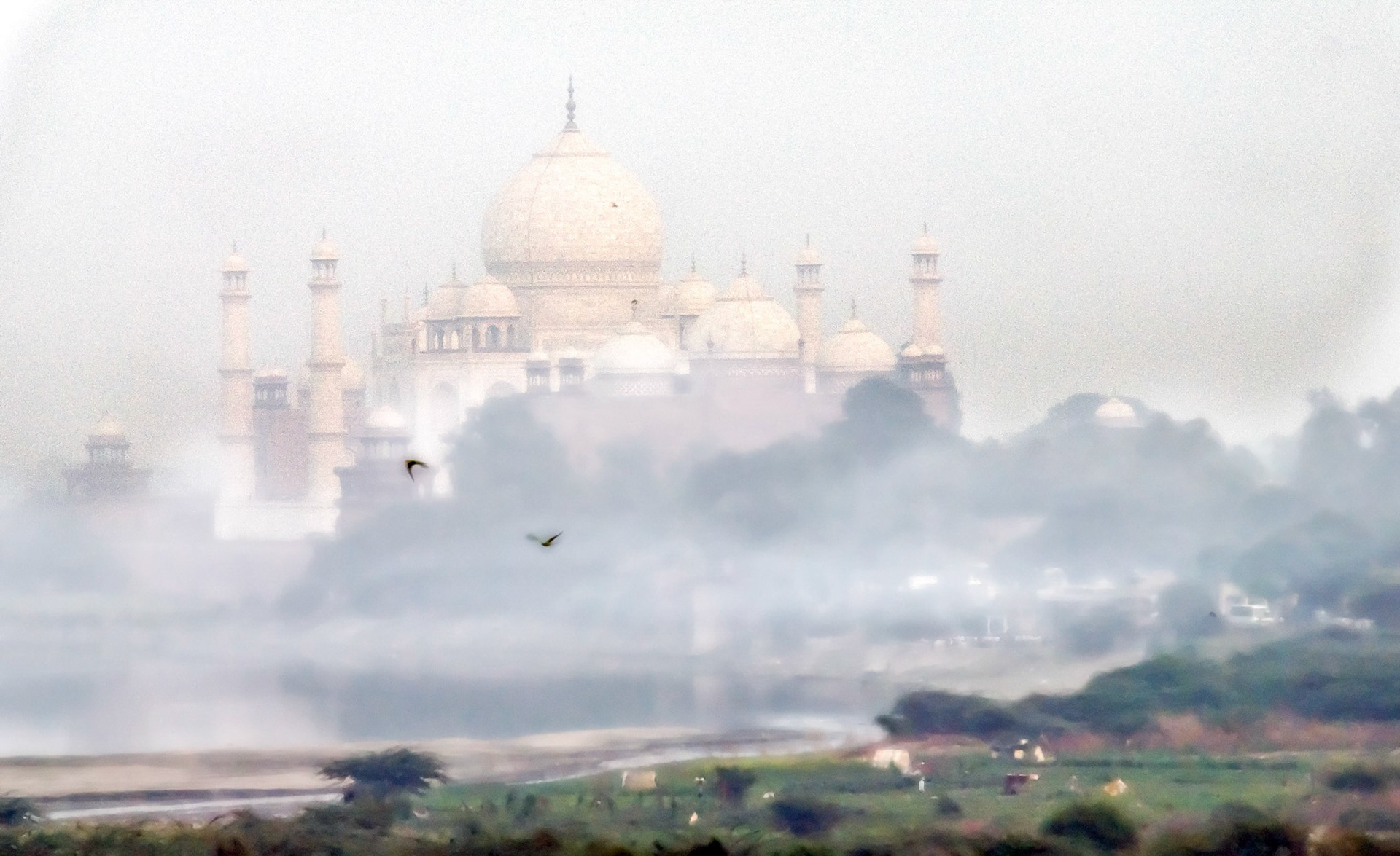 The Taj seen through the mist over the Yamuna river