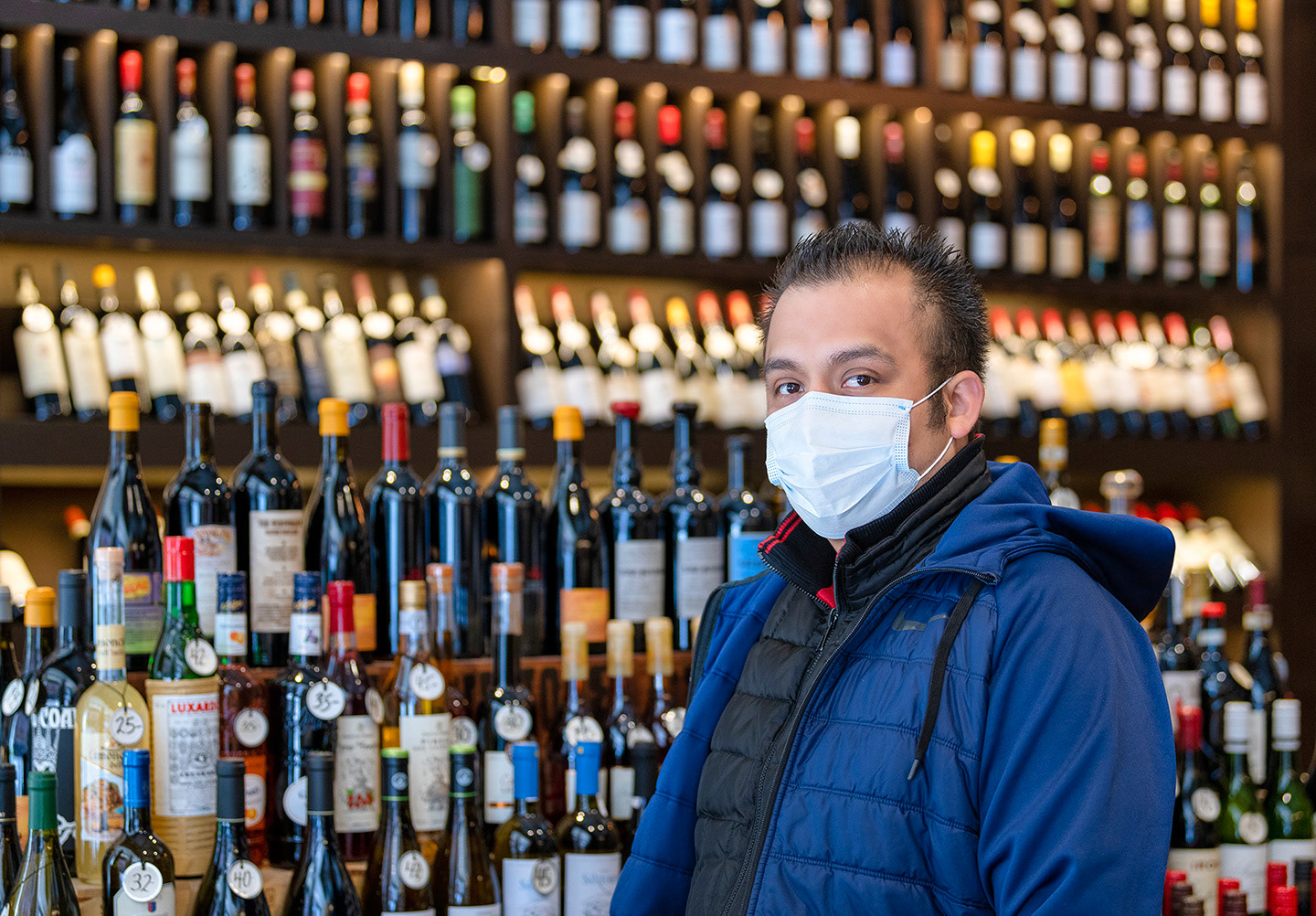 Local wine shop proprietor in his COVID19 protective mask during lock down in NYC