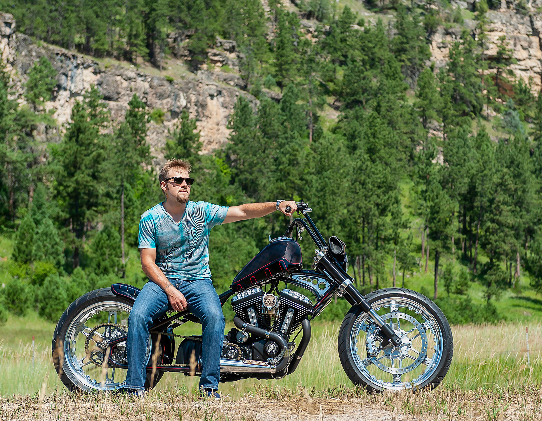 Posing on a custom cruiser in the South Dakota mountains