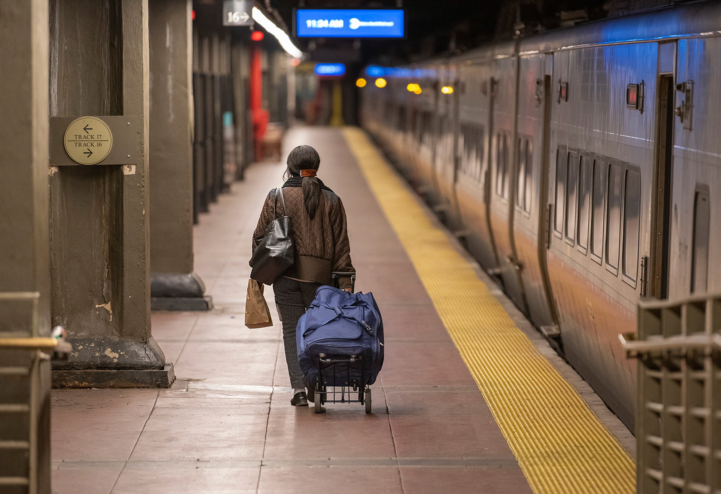 One lone passenger makes her way to the train on track 16 at New York City’s Grand Central Station