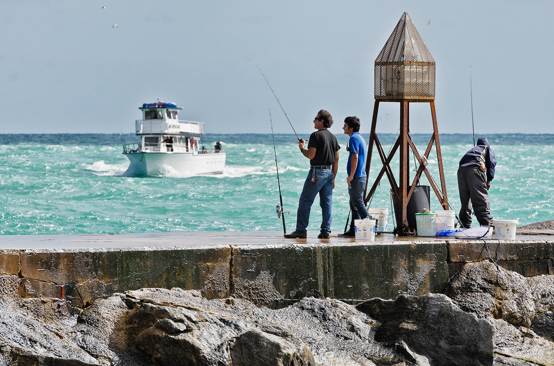 Jetty fishing the Bal Harbour Inlet Jetty is so popular not a day goes by without a small crowd.  Charter fishermen return from an offshore fishing adventure to the Inter Coastal waterway nia the Bal Harbour Inlet.