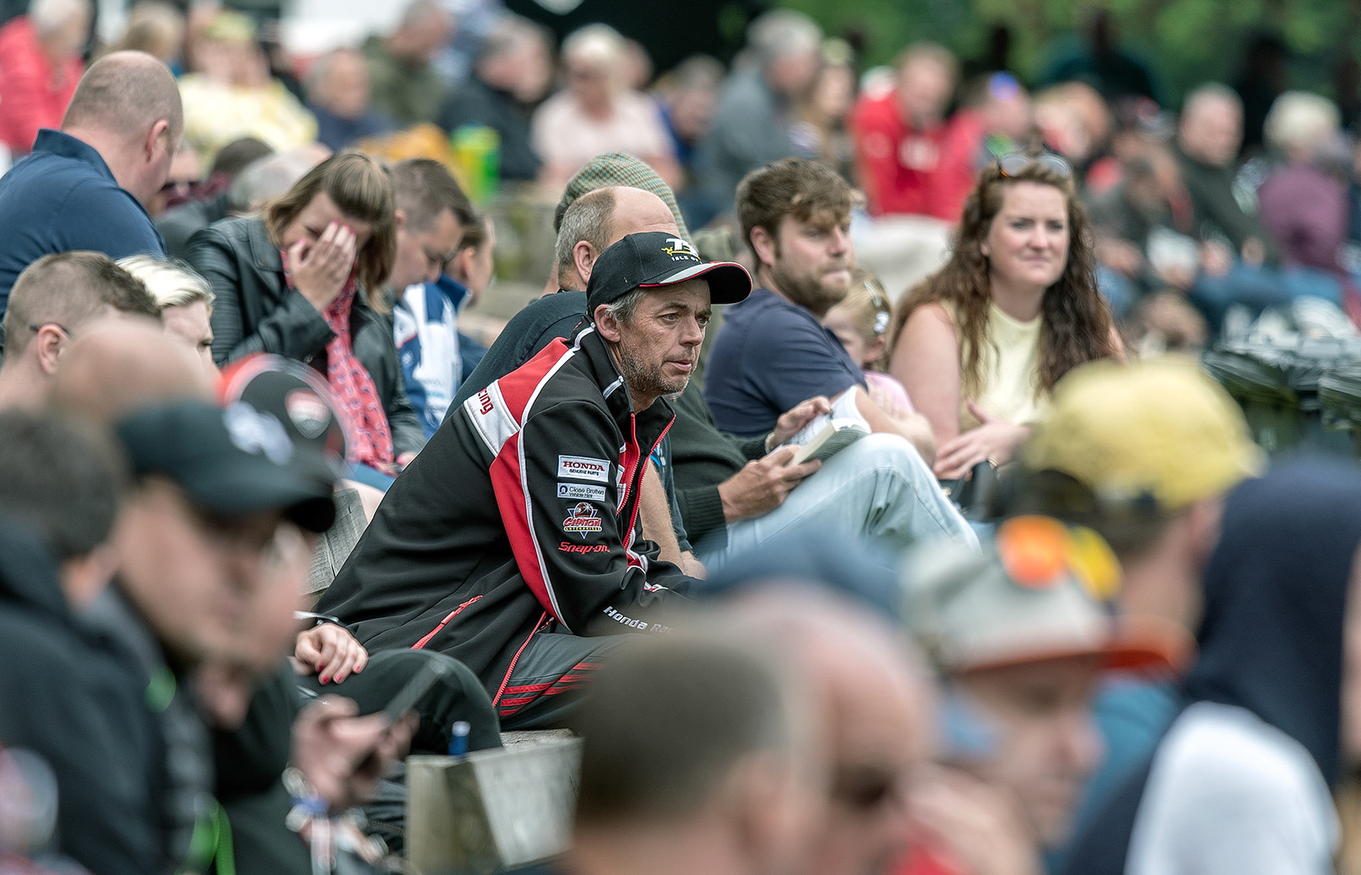 Isle of Man TT fans at Braddan Bridge wait for racing to start